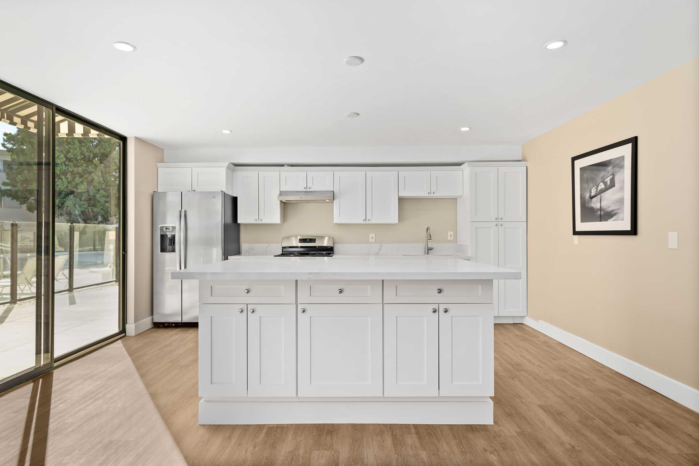 a large kitchen with white cabinets