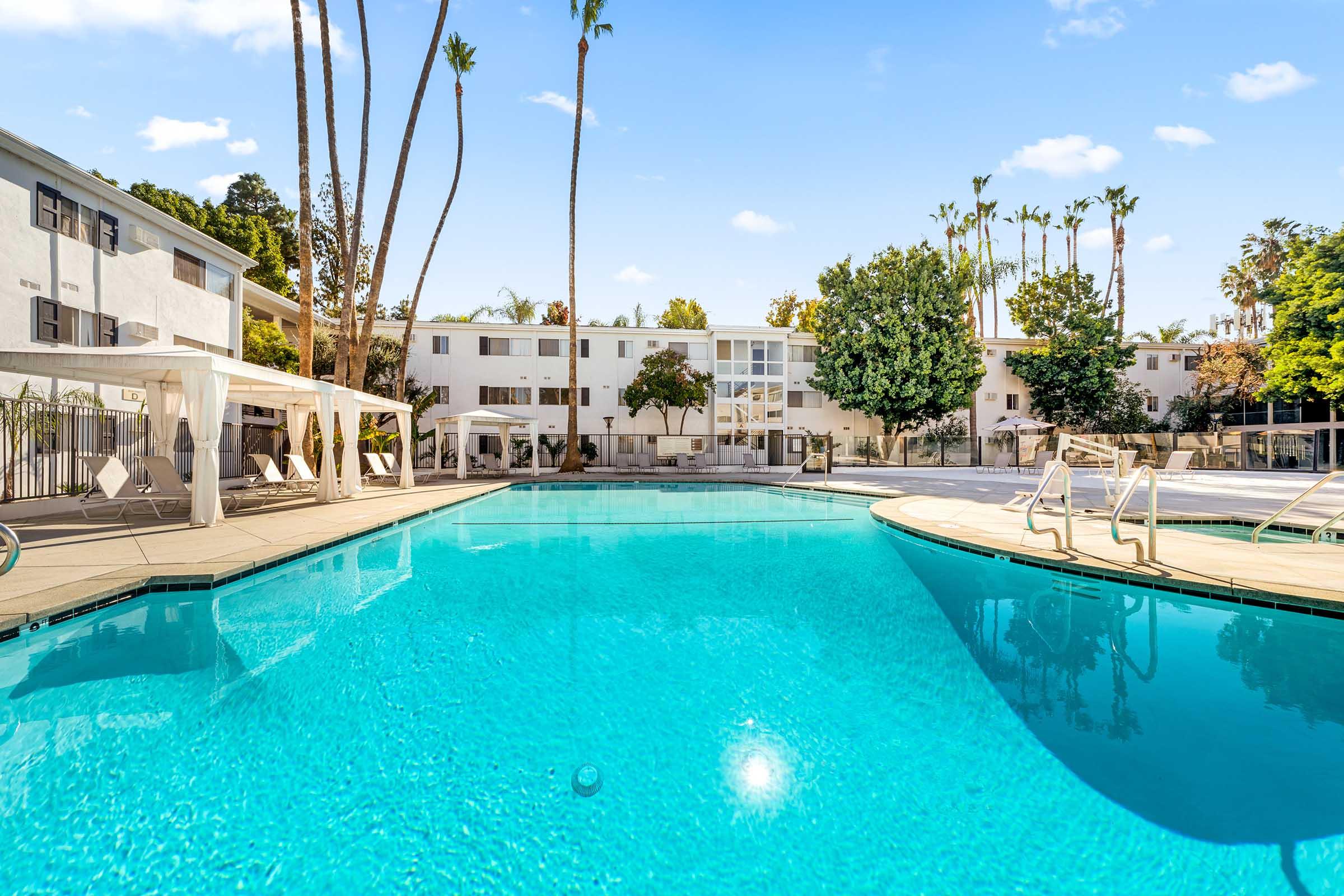 a swimming pool with cabanas