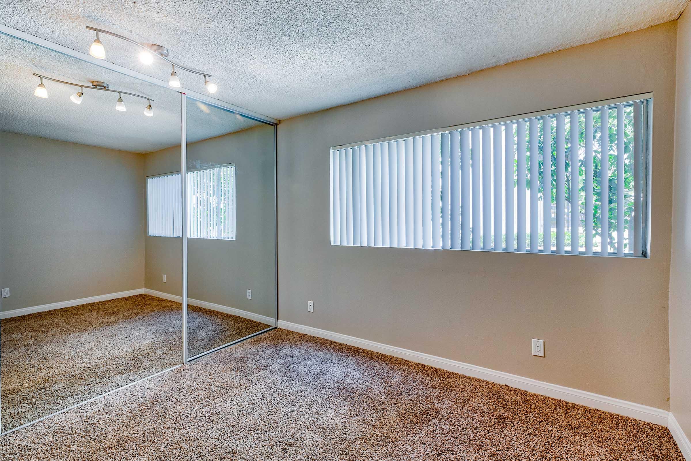 an empty bedroom with a window