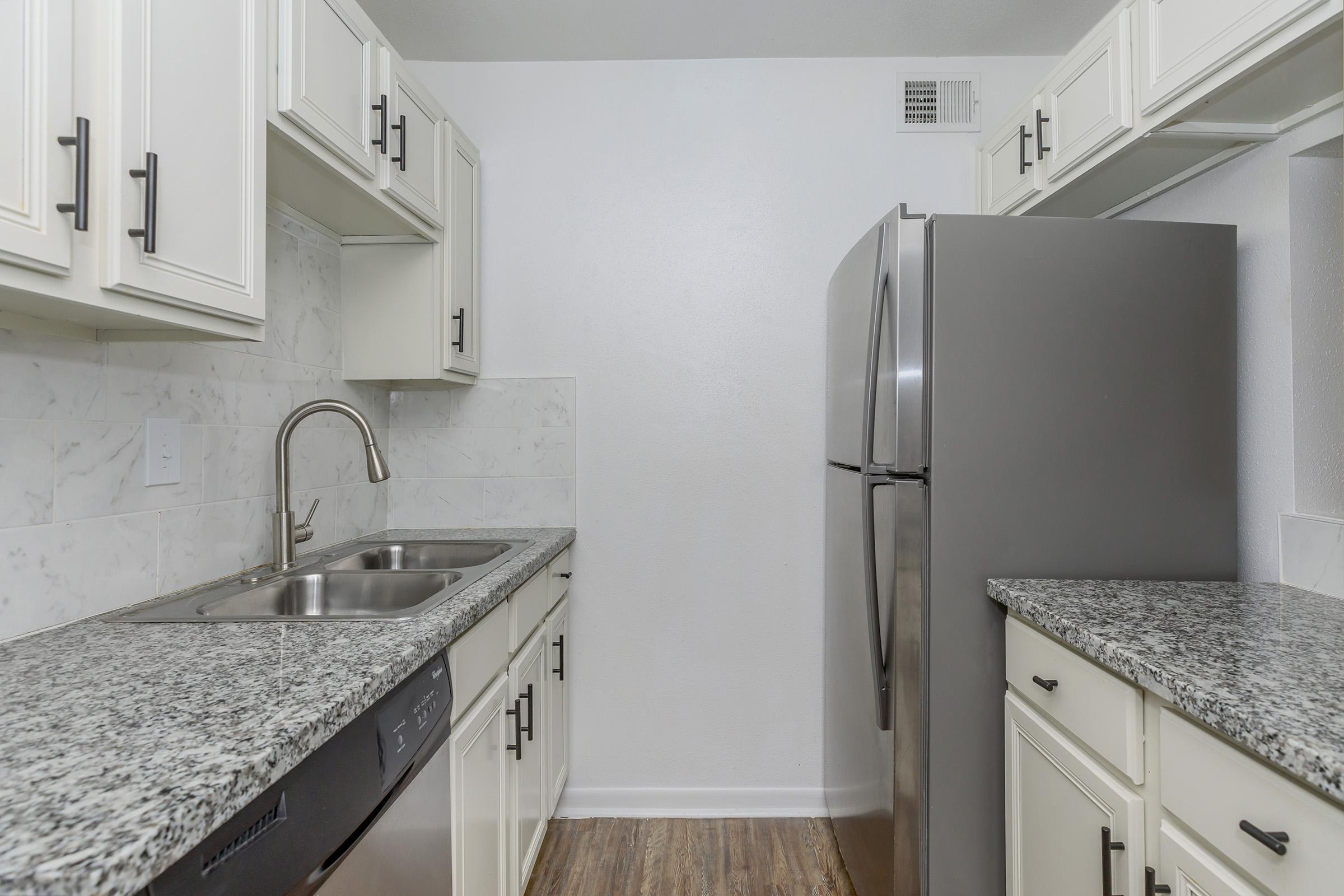 a kitchen with a sink and a mirror