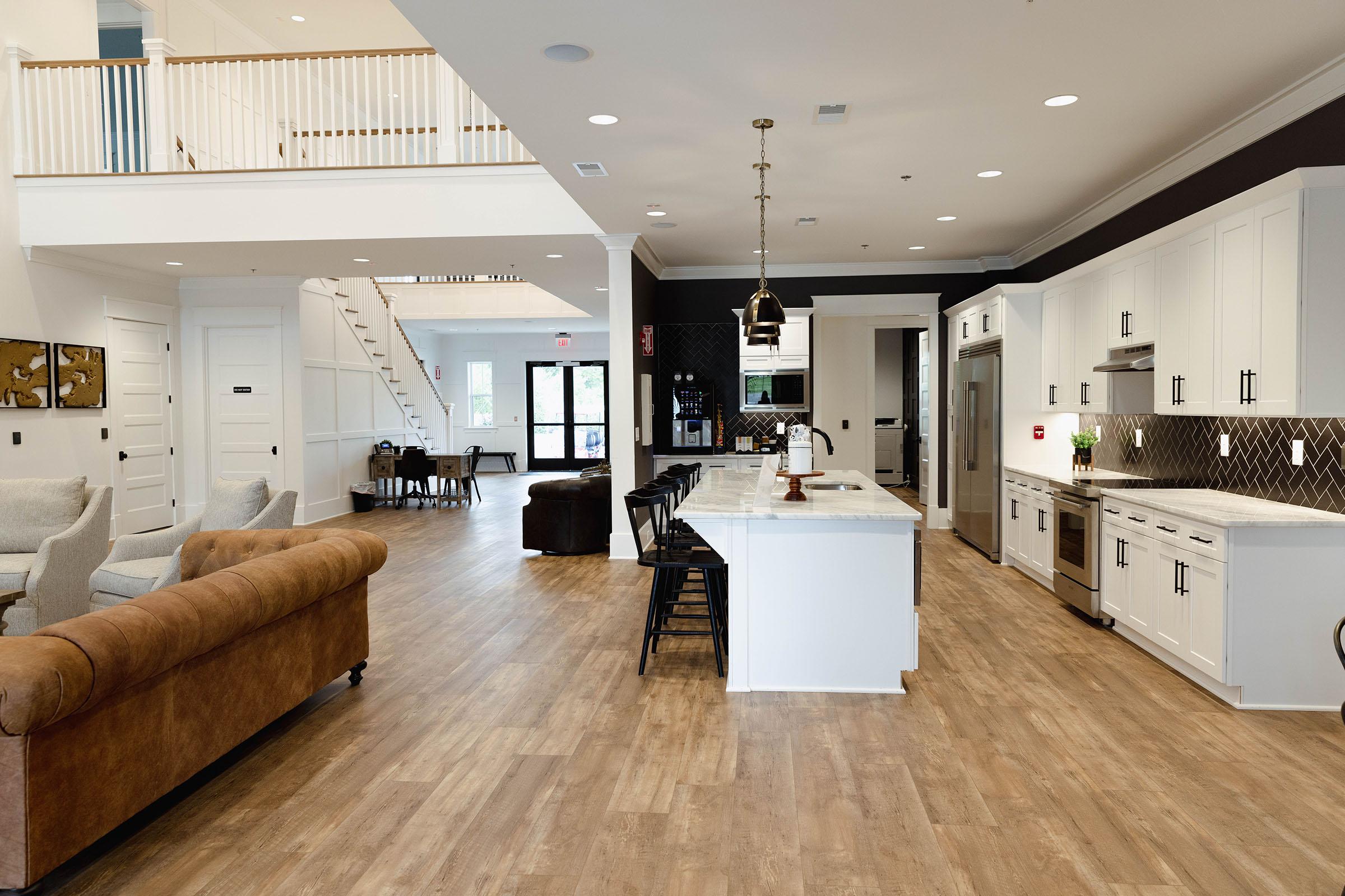 a living room filled with furniture on top of a hard wood floor