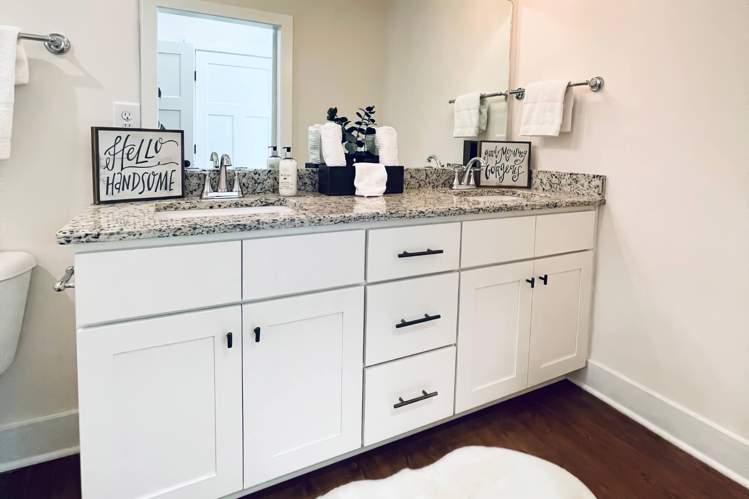 a kitchen with a sink and a mirror