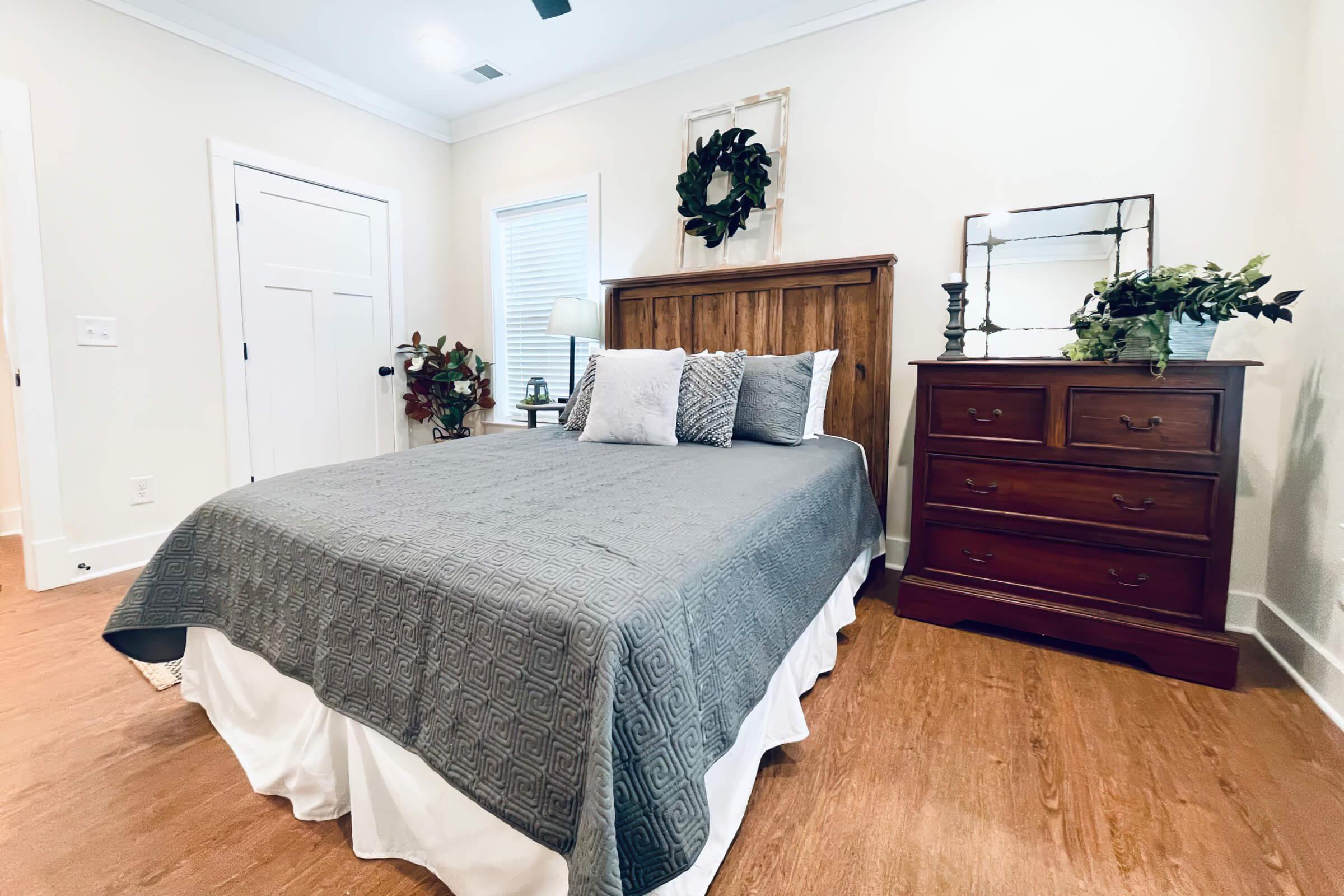 a bedroom with a bed and desk in a room