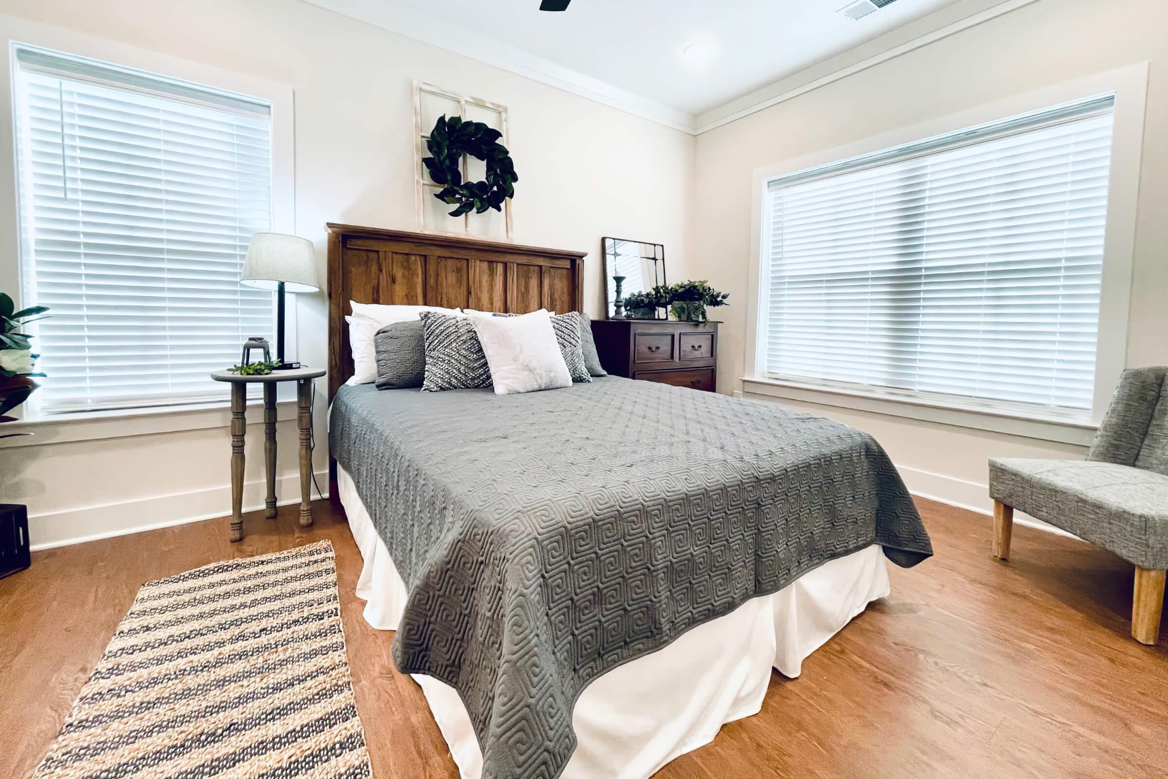 a bedroom with a bed and desk in a room