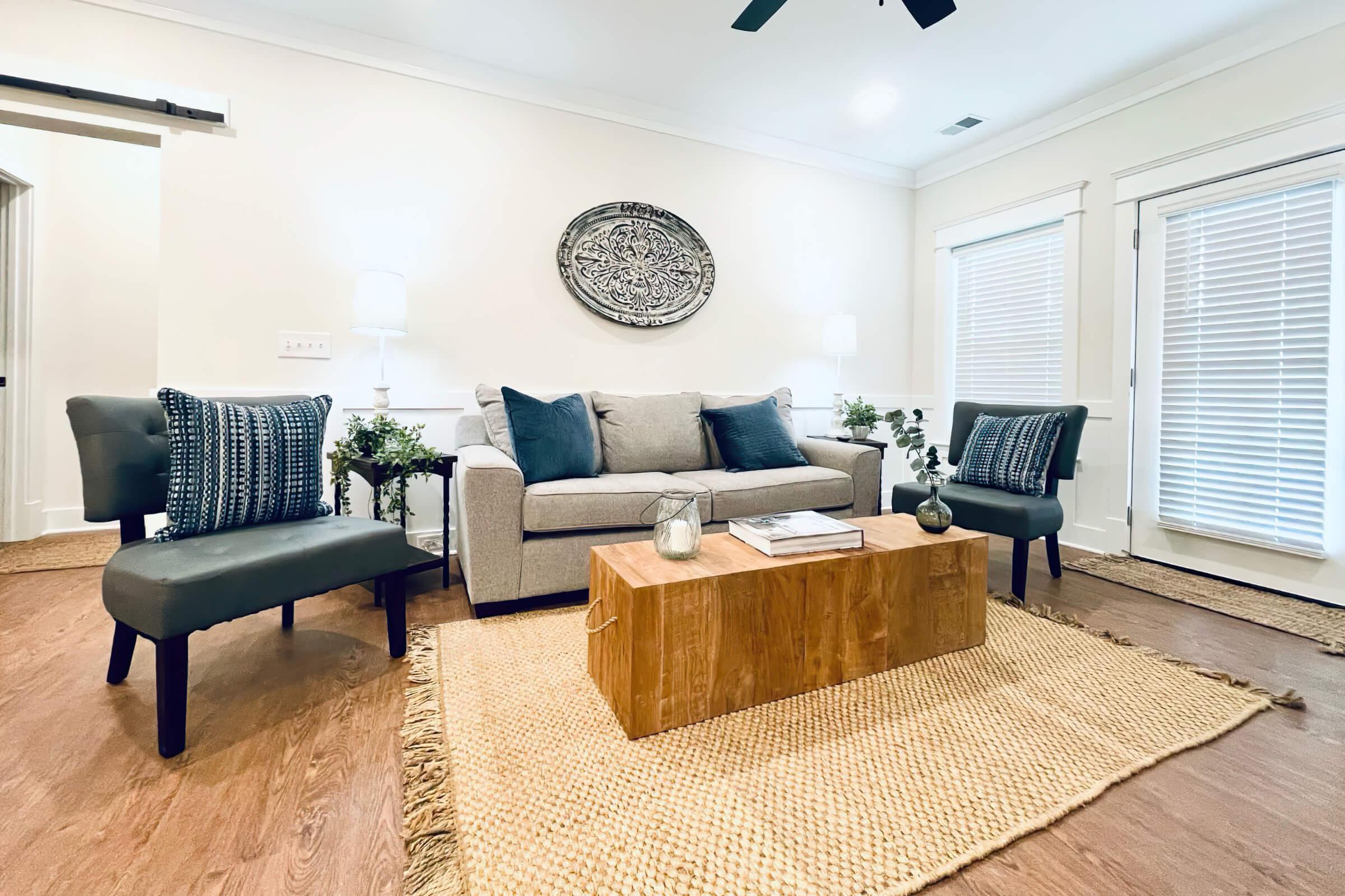 a living room filled with furniture and a large window