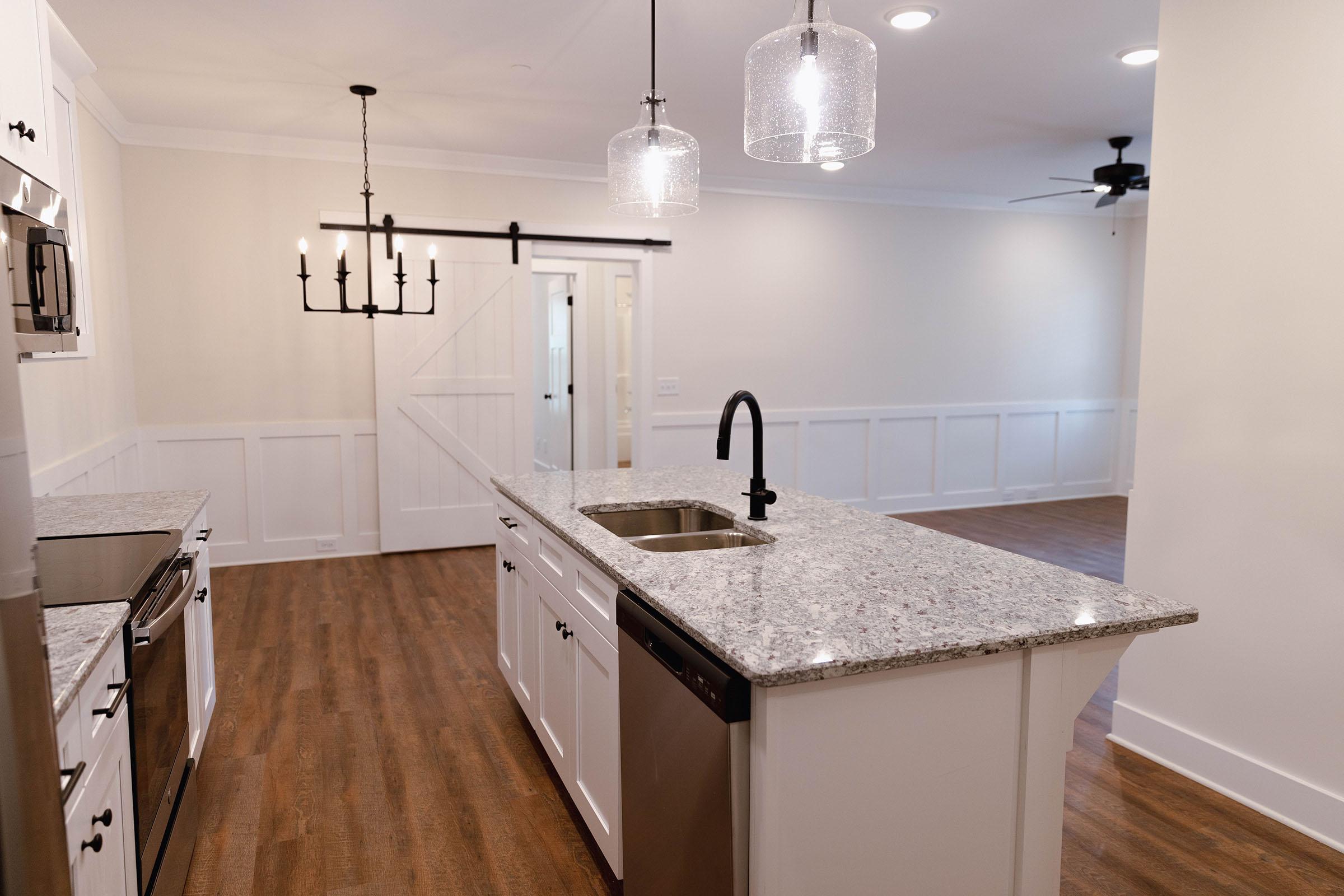 a kitchen with a sink and a mirror