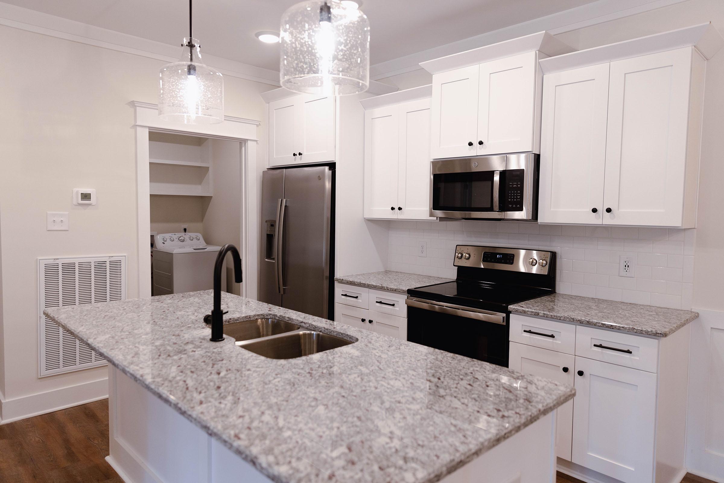 a kitchen with a sink and a refrigerator