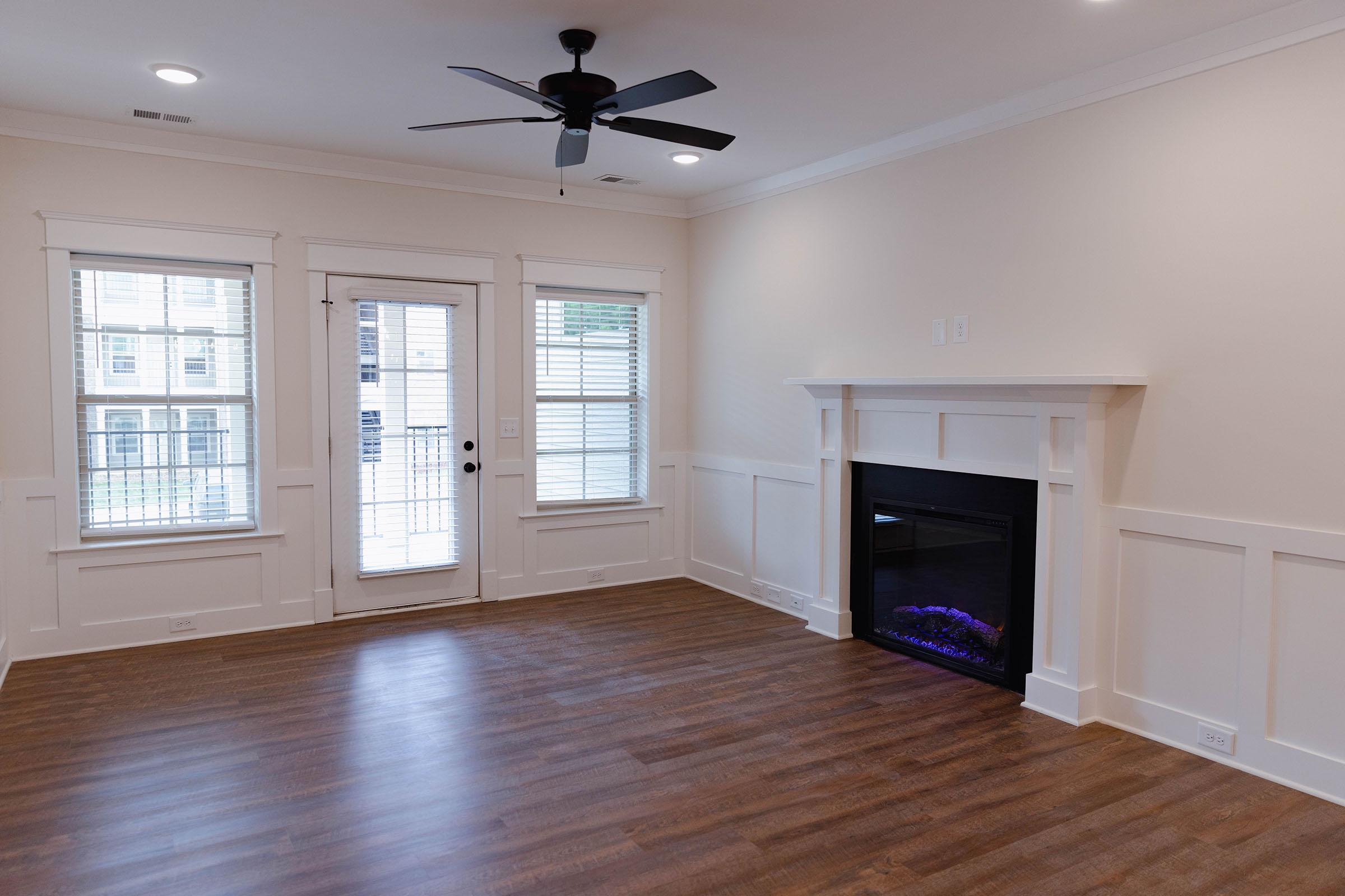 a living room filled with furniture and a large window