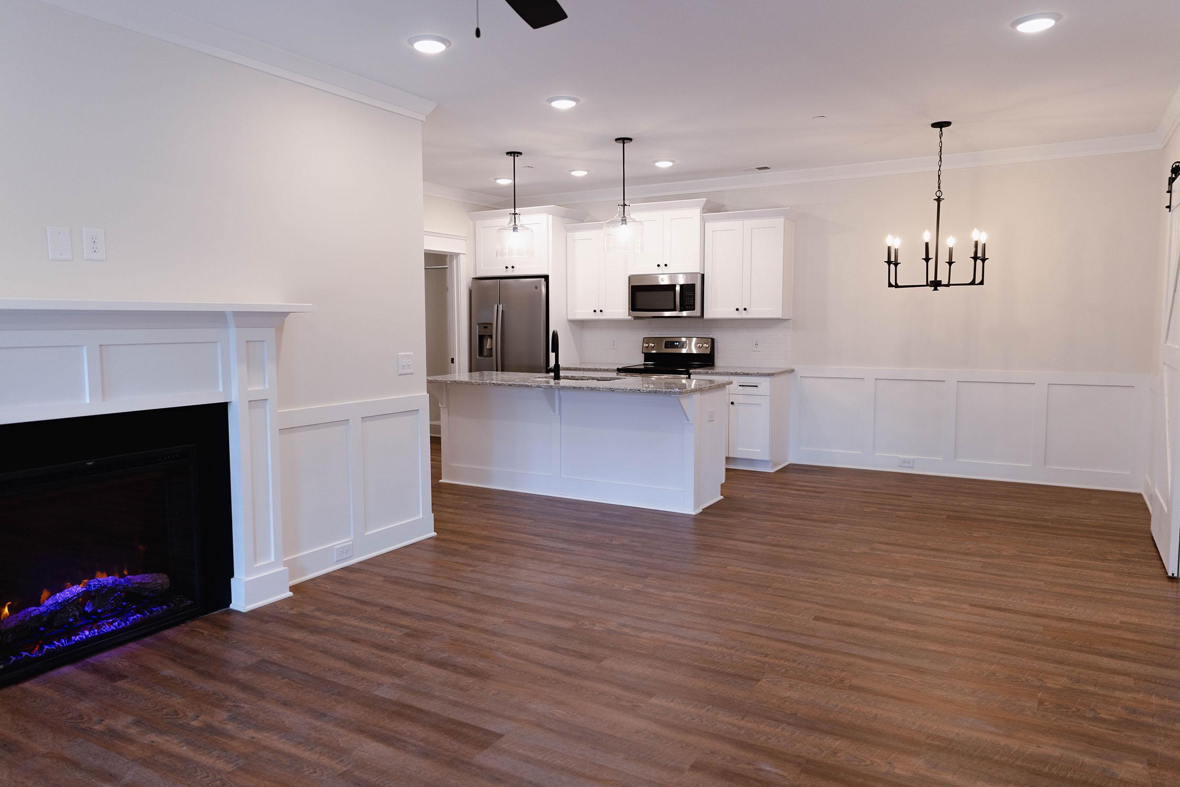 a kitchen with a wood floor in a room