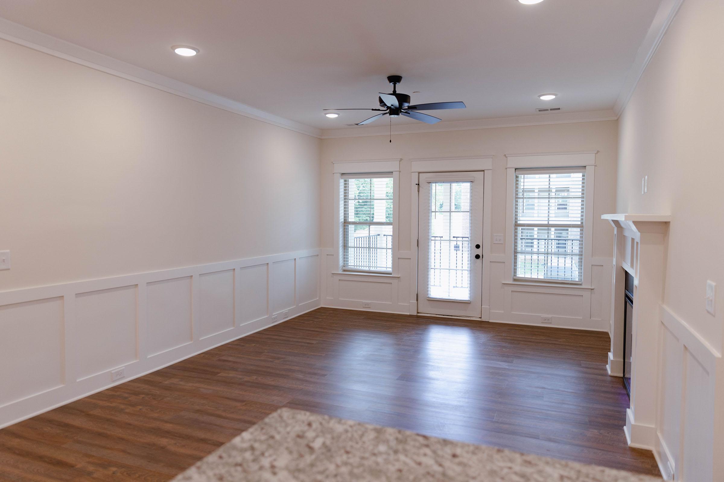 a kitchen with a hard wood floor next to a window