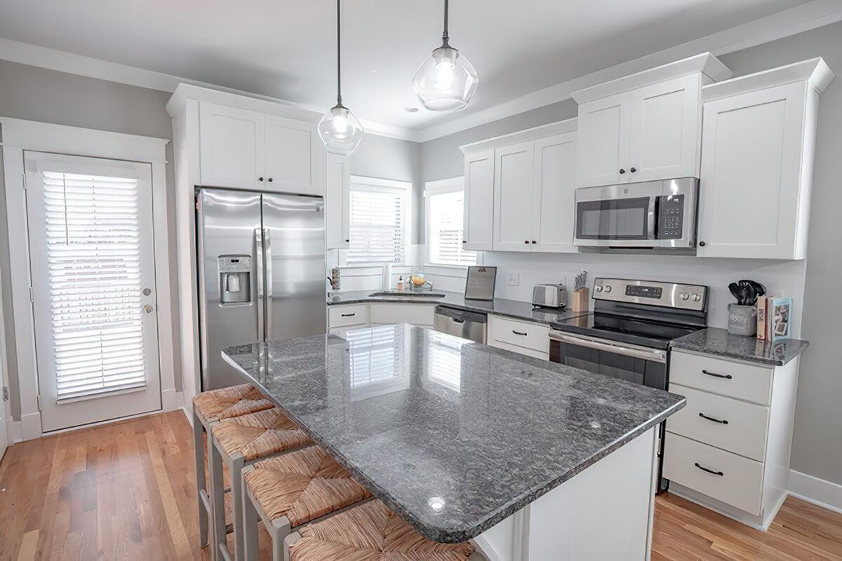 a modern kitchen with stainless steel appliances and wooden cabinets