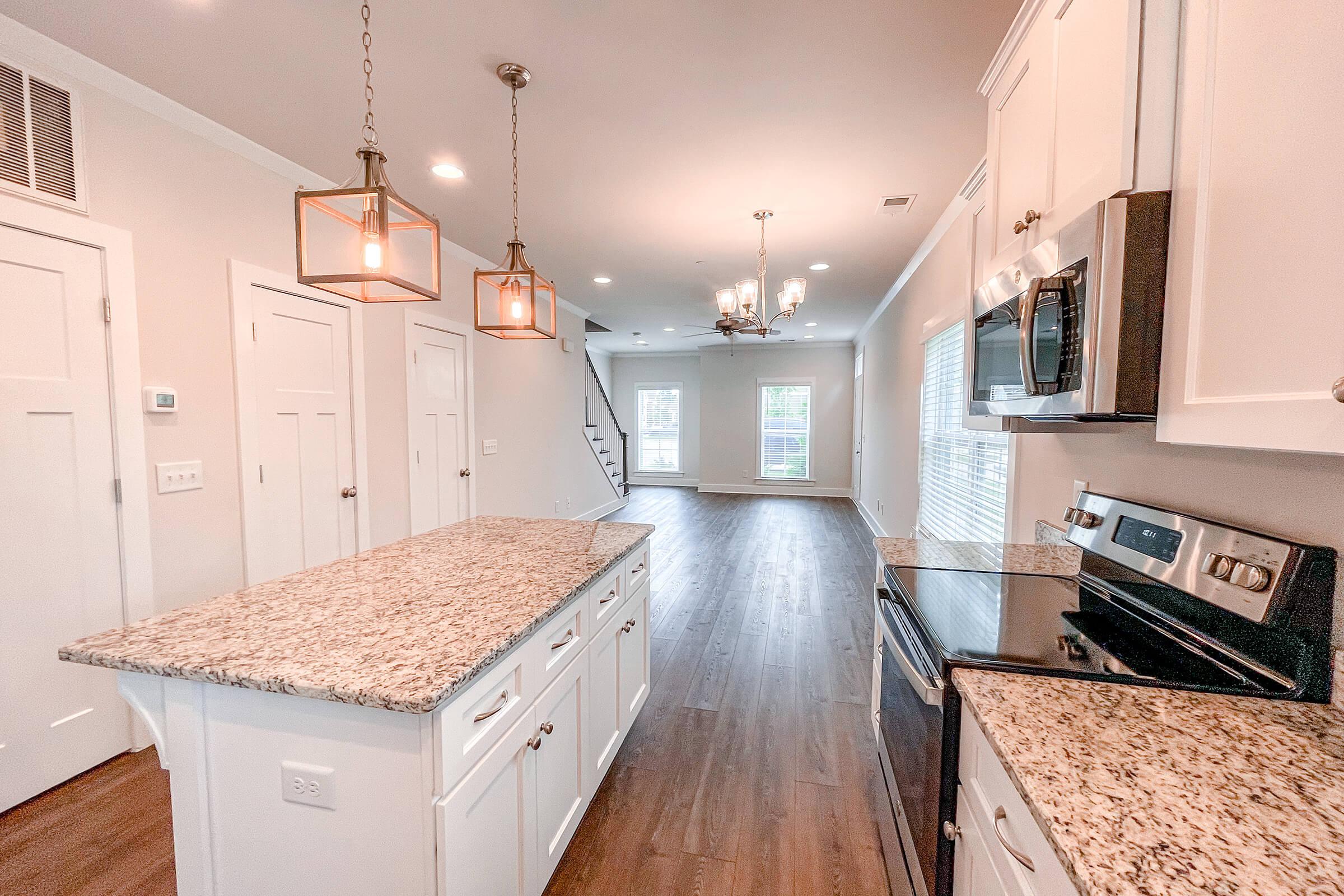 a kitchen with a stove top oven sitting inside of a bedroom