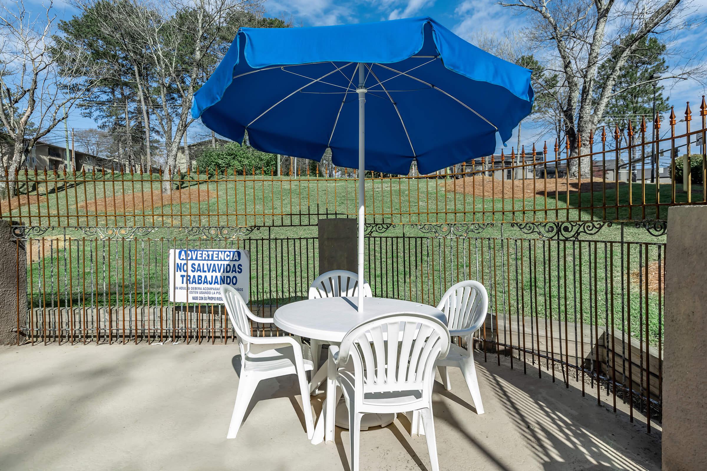 an umbrella sitting on top of a wooden fence