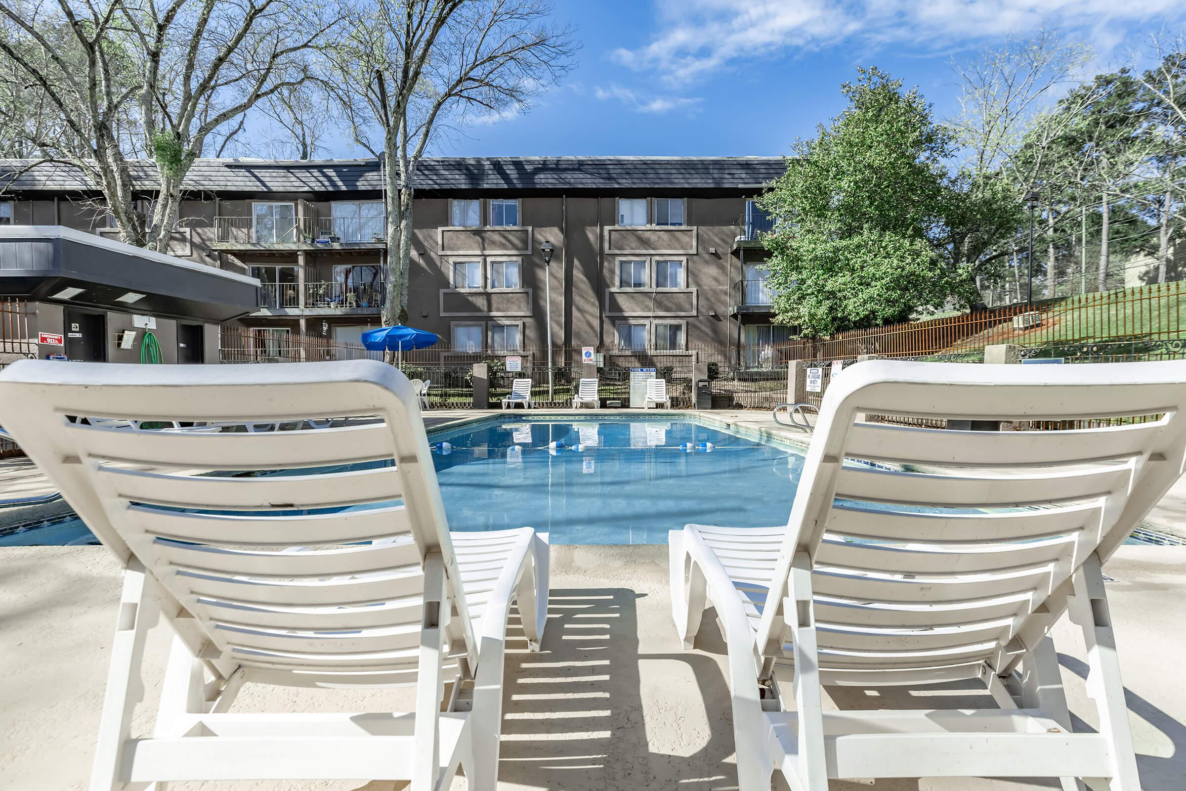 a row of lawn chairs sitting on top of a wooden bench