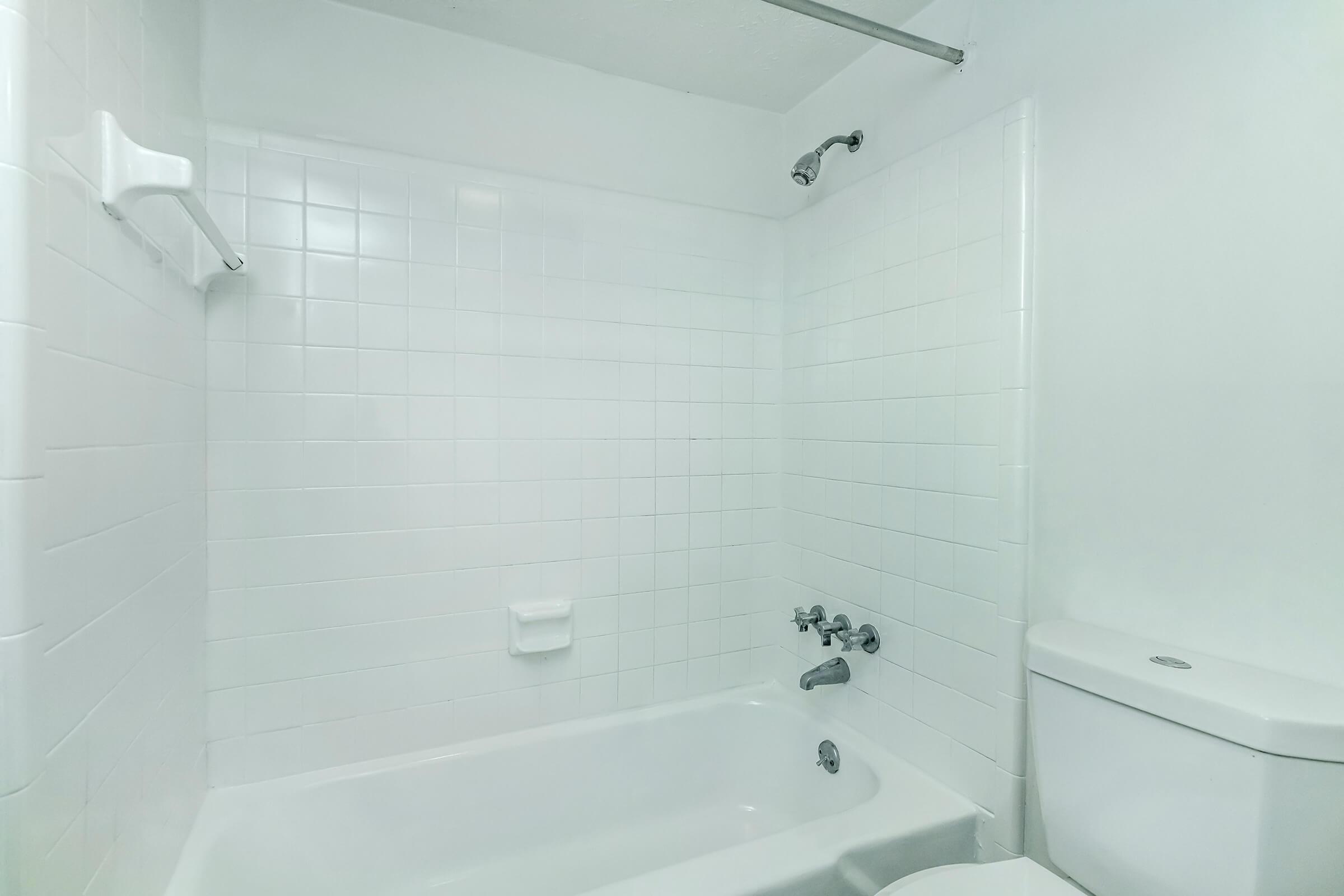 a close up of a sink in a tiled room