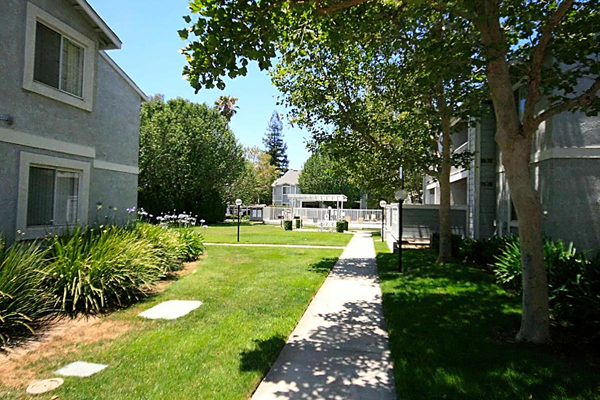 Belcourt Apartments walkway with green grass