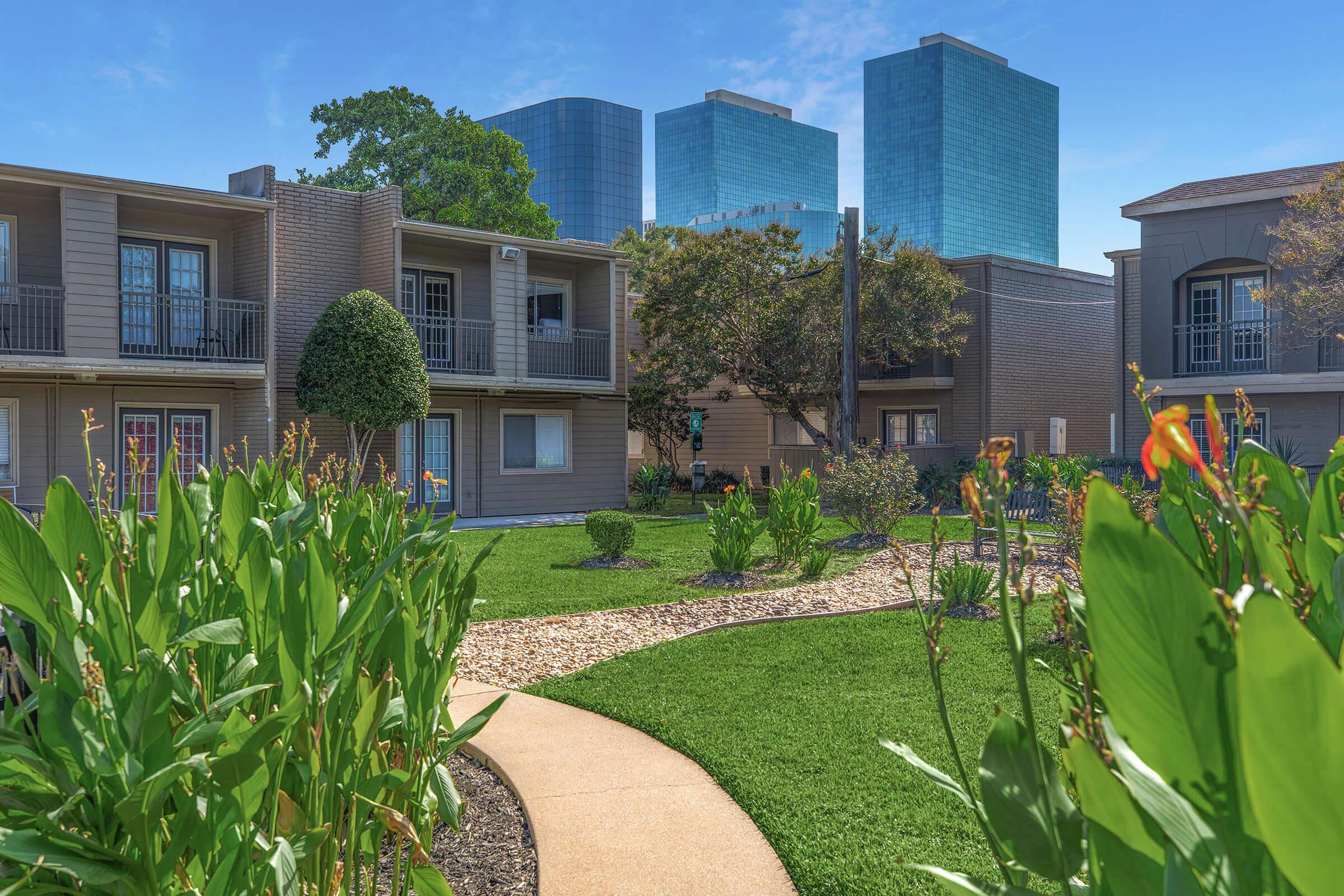 a close up of a flower garden in front of a building