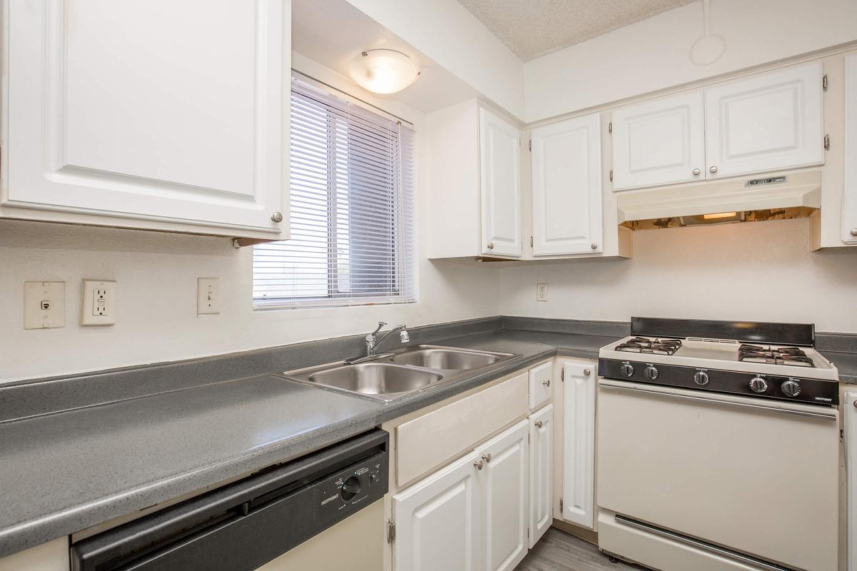 a stove top oven sitting inside of a kitchen
