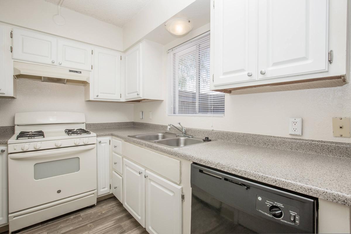 a stove top oven sitting inside of a kitchen