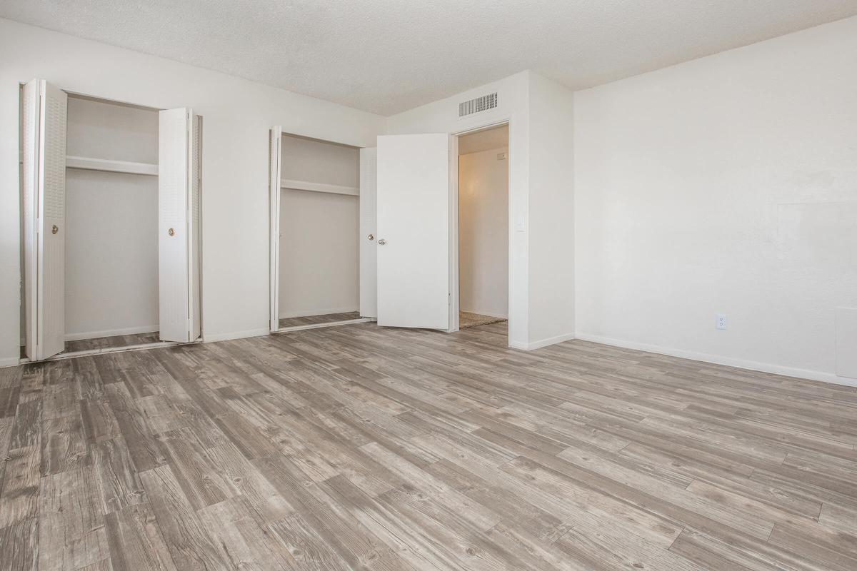 a large empty room with a wooden floor