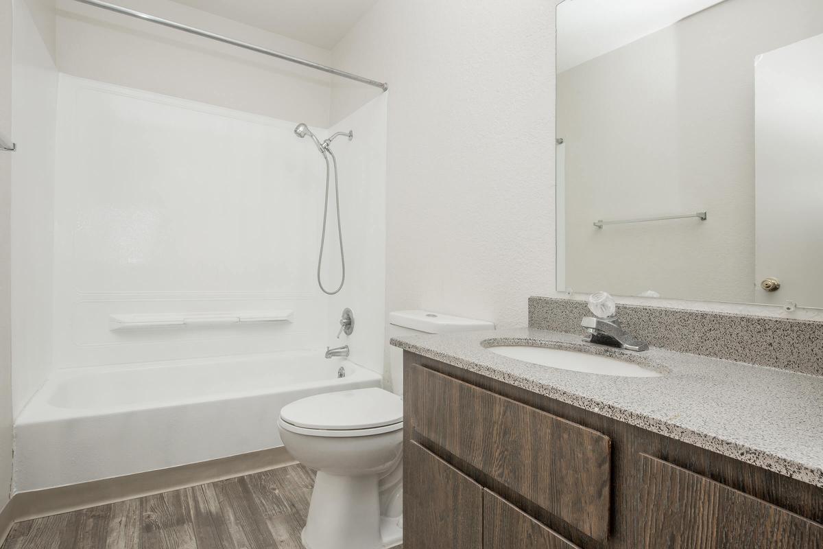a large white tub sitting next to a sink