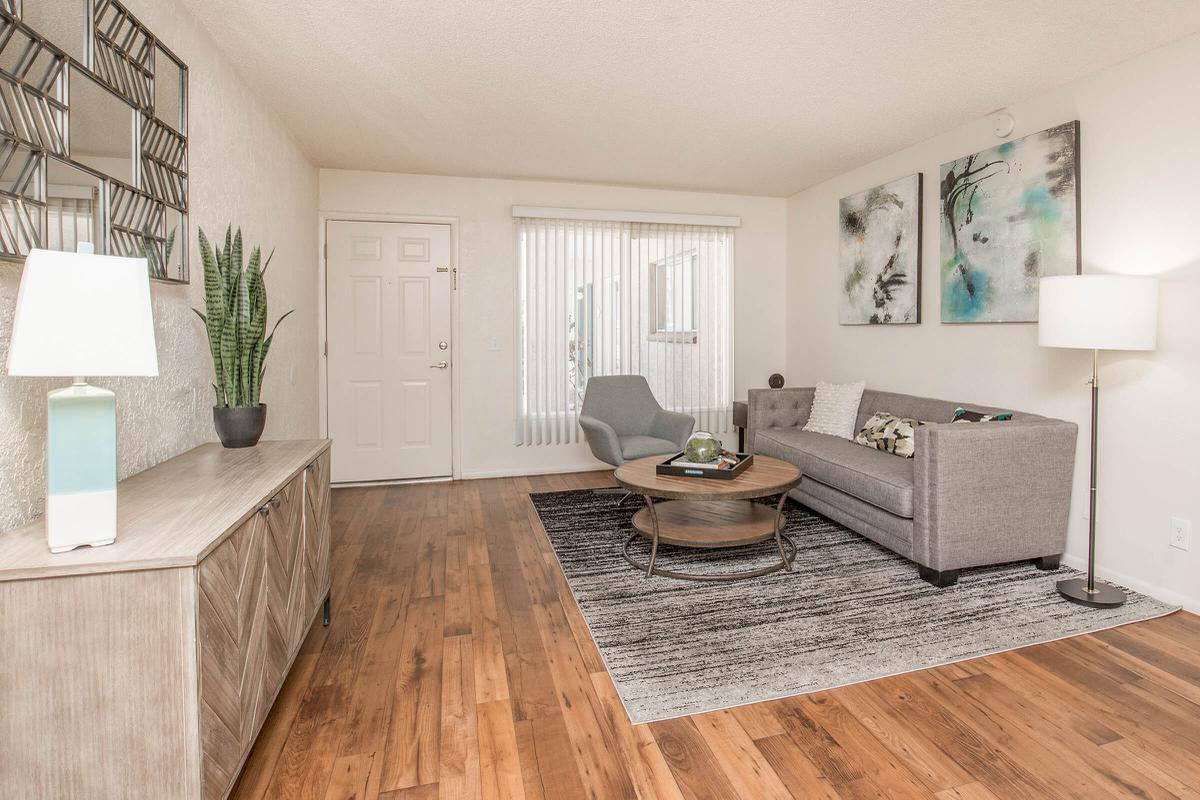 a living room filled with furniture and a large window