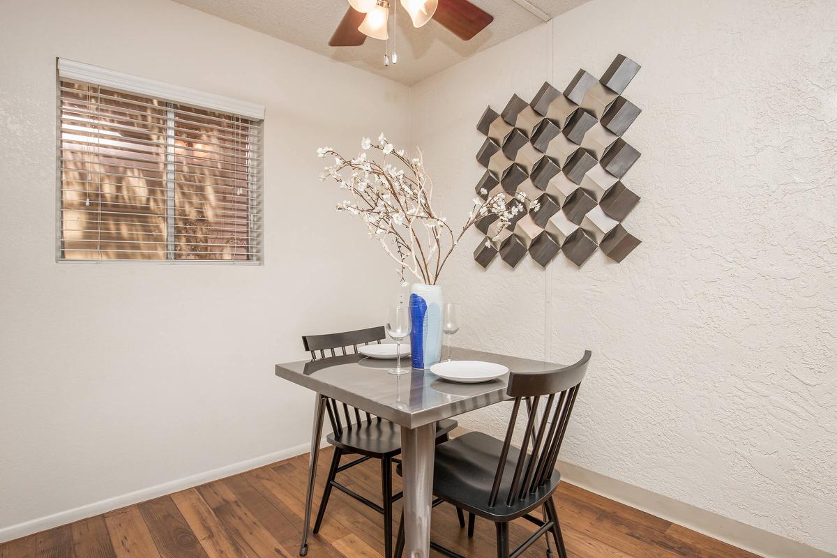 a room filled with furniture and vase on a table
