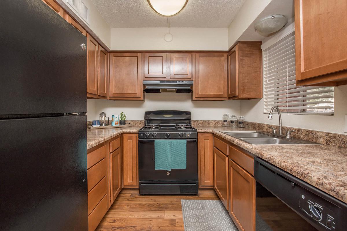 a modern kitchen with stainless steel appliances and wooden cabinets