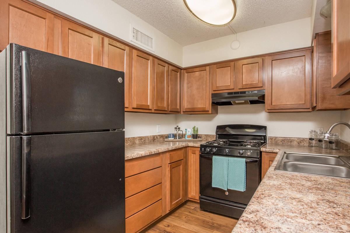 a kitchen with stainless steel appliances and wooden cabinets