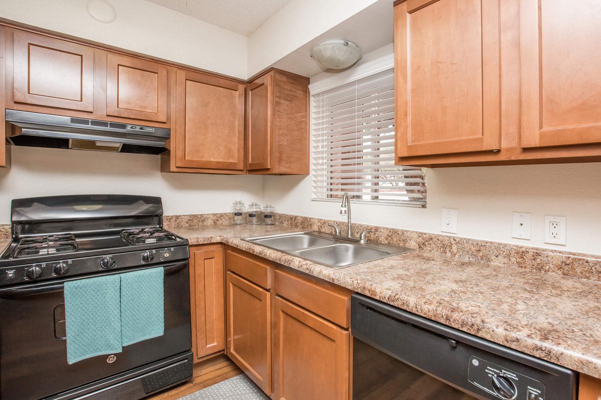 a kitchen with stainless steel appliances and wooden cabinets