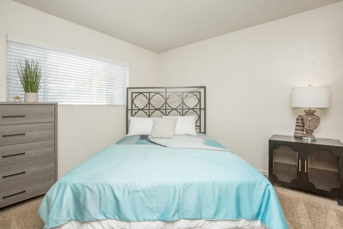 a bedroom with a bed in a room