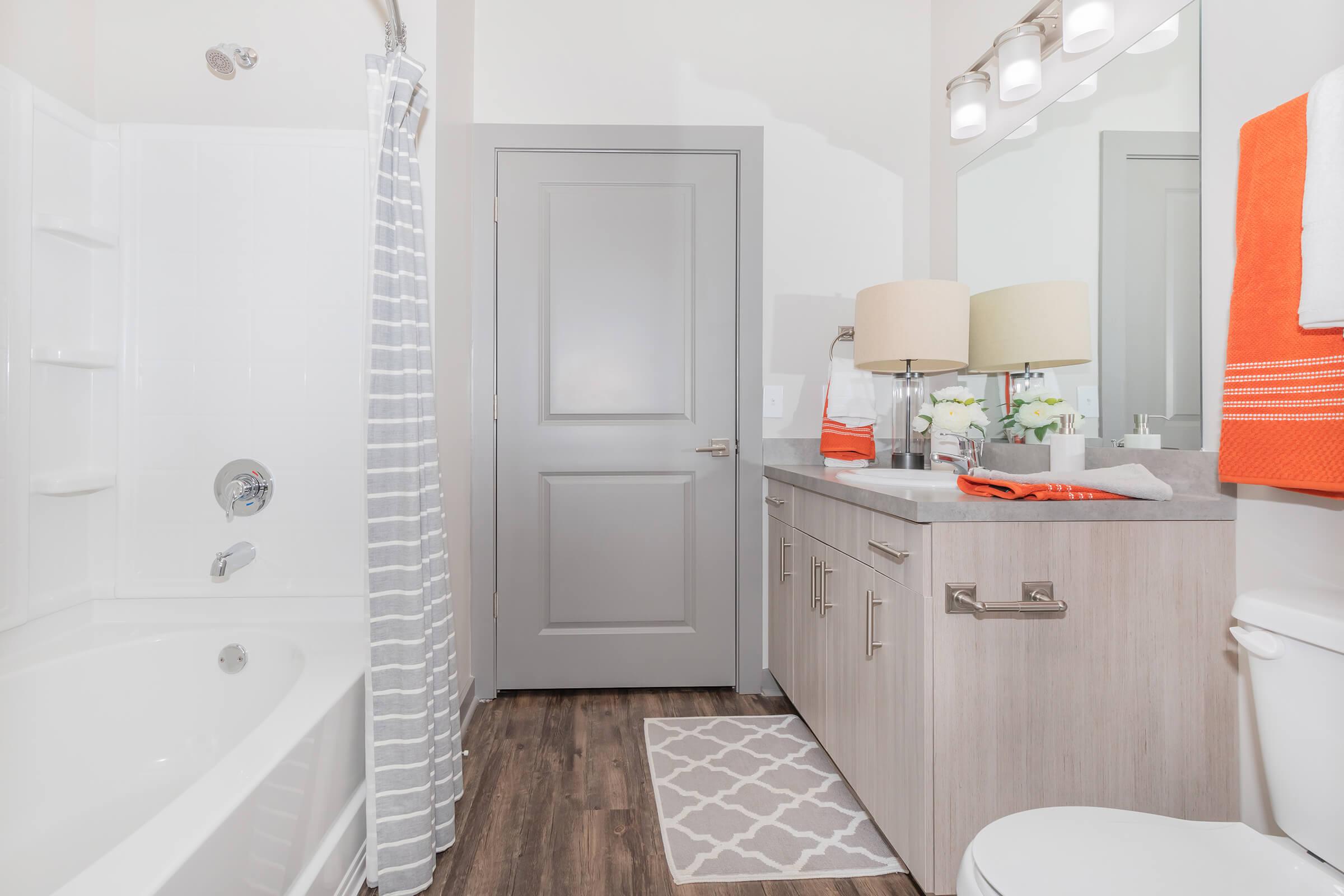 a large white tub next to a sink