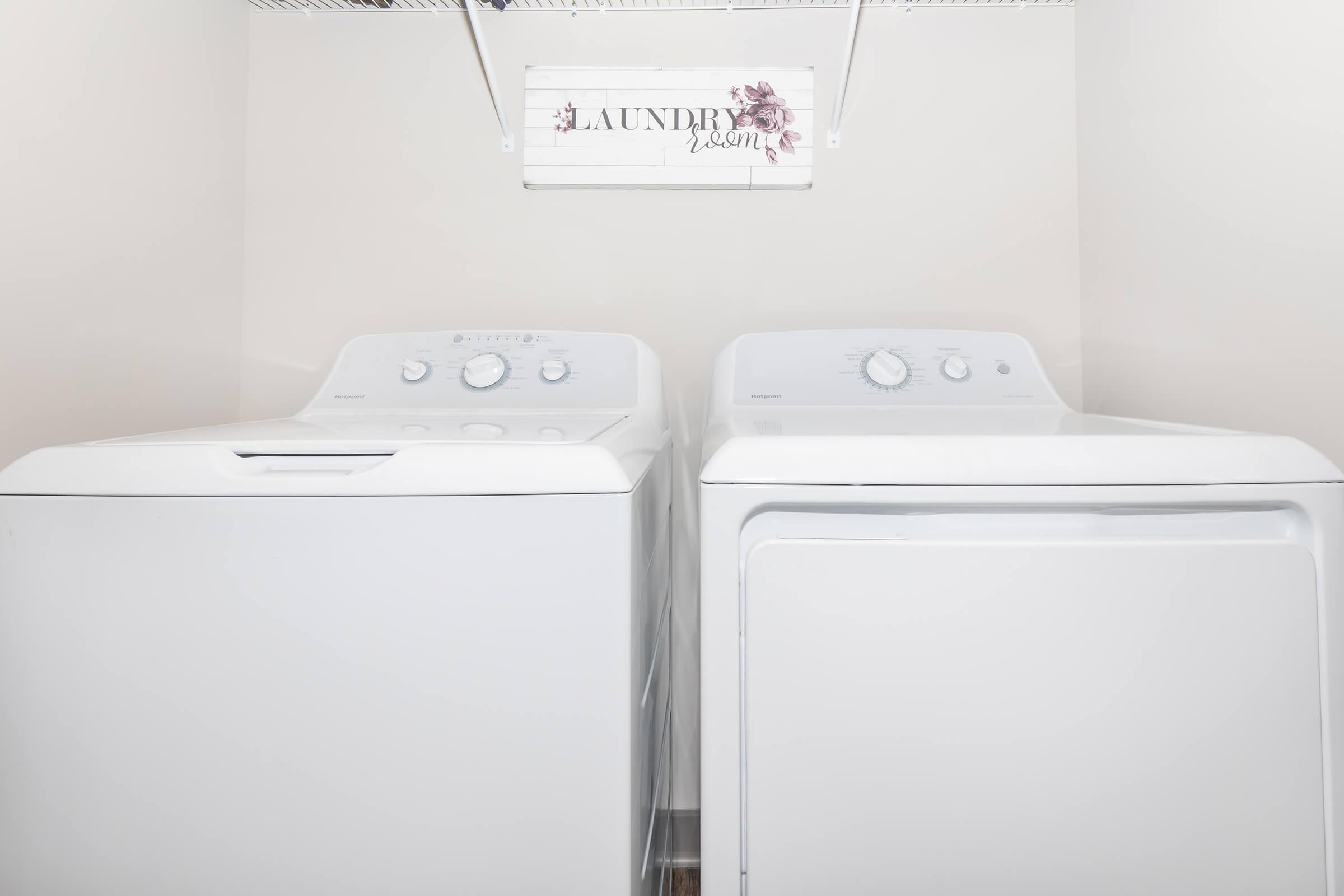 a white microwave oven sitting on top of a refrigerator