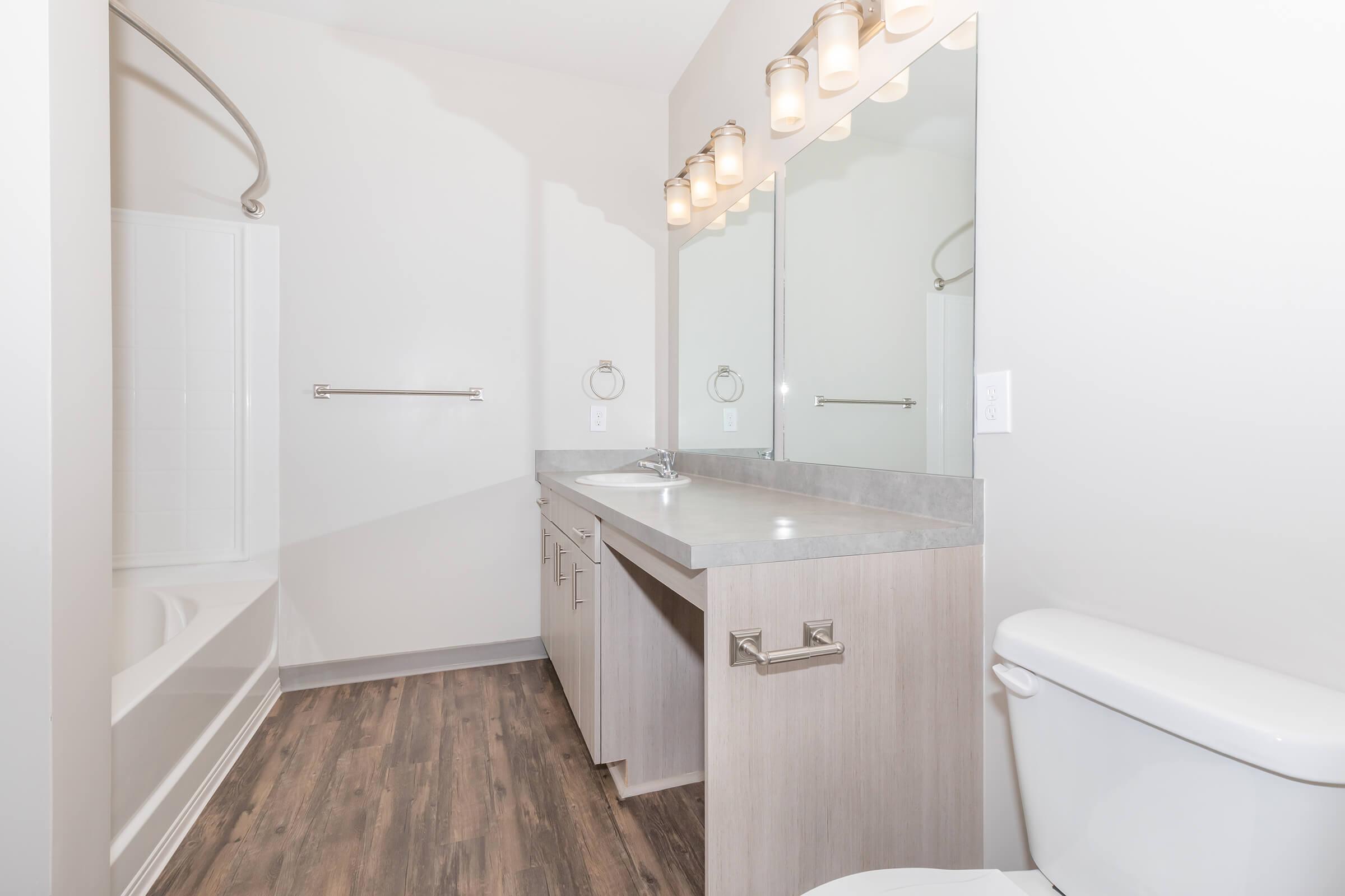 a large white tub sitting next to a sink