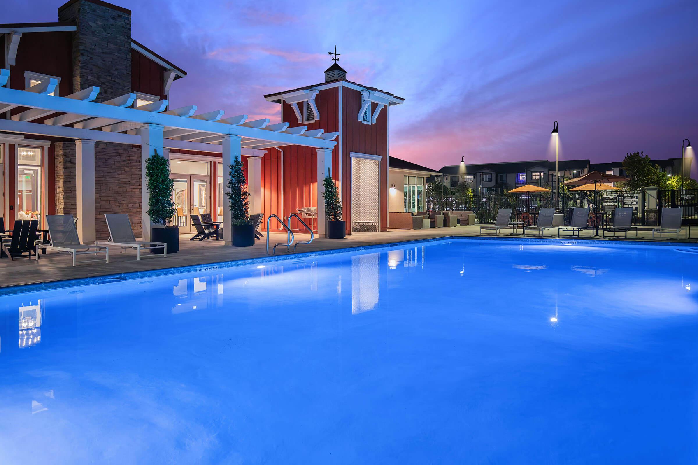 a blue pool of water in front of a building