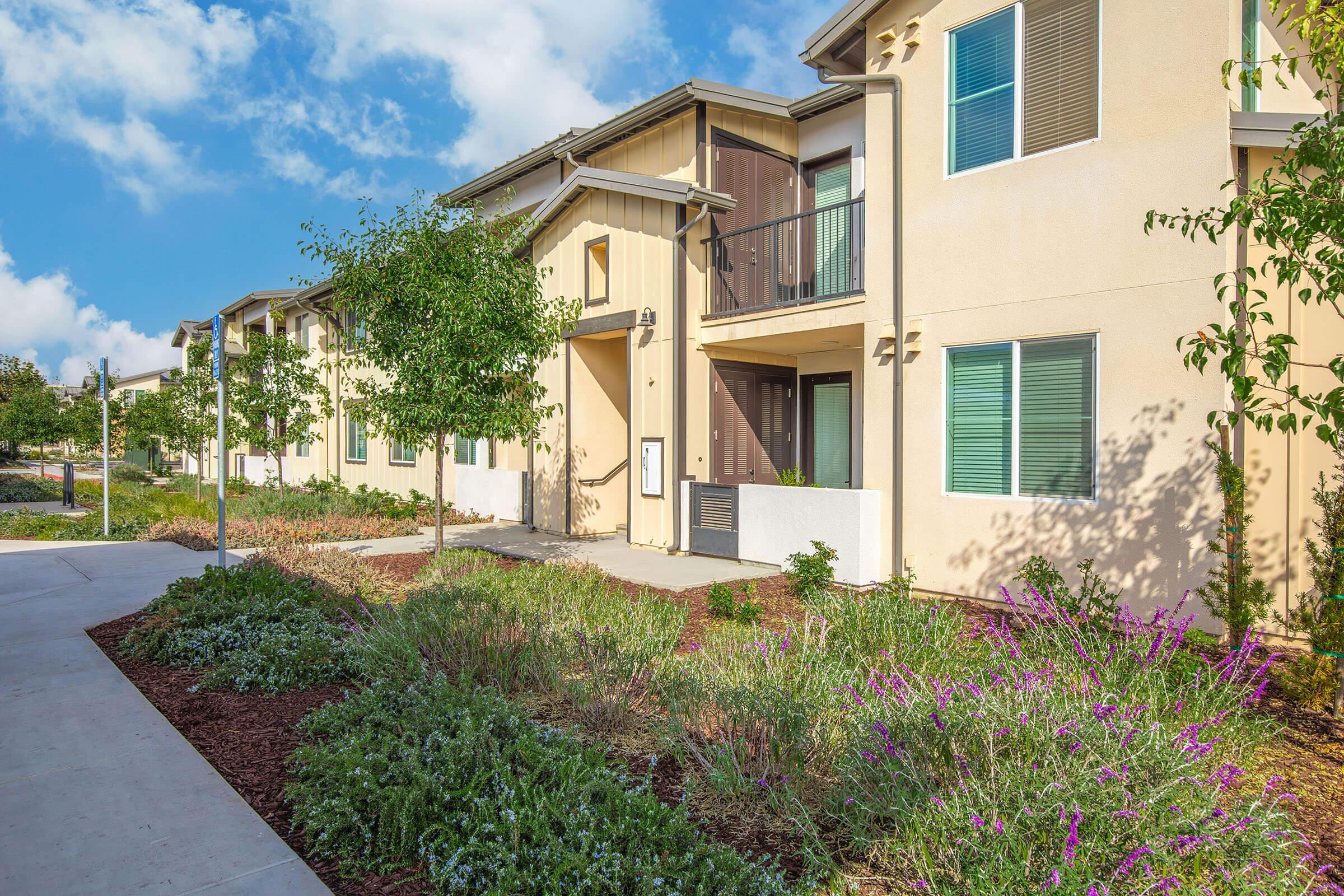 a house with bushes in front of a building