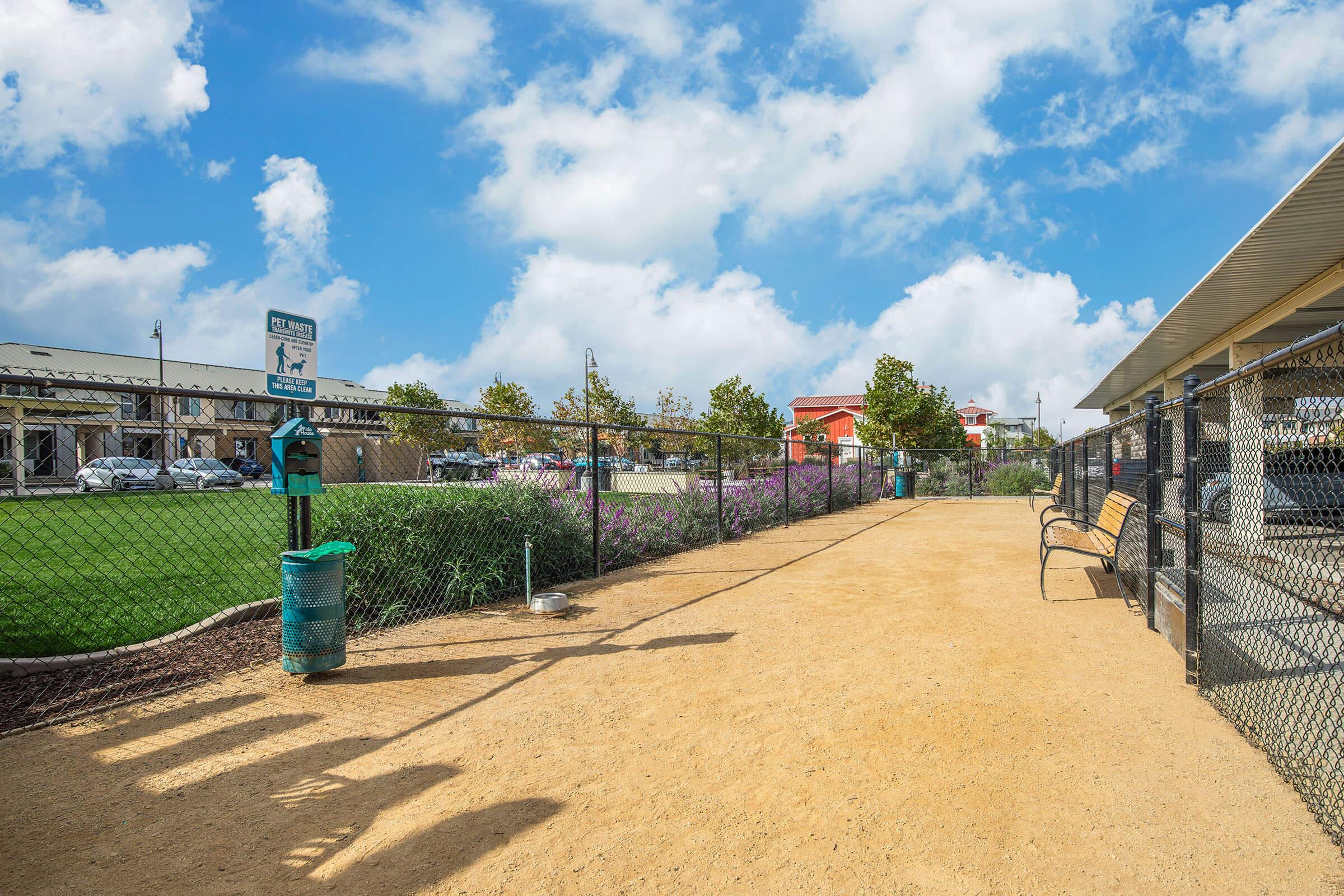 a group of people walking down a dirt road