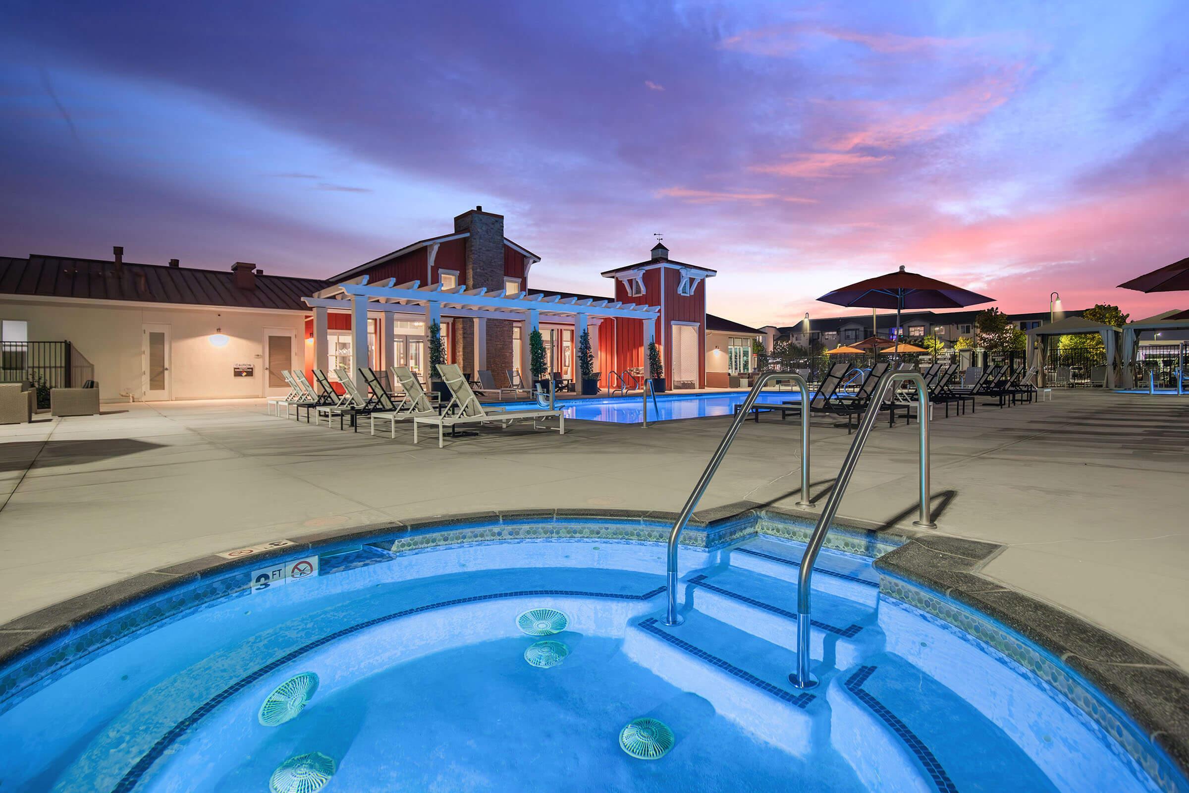 Pet-Friendly Apartments in Santa Maria, CA - Azure Apartments - Swimming Pool with a Spa, Cabanas, and Lounge Seating.