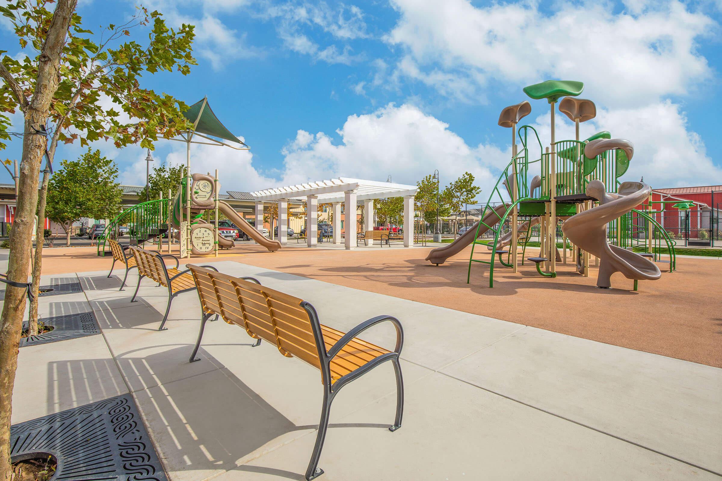 Santa Maria, CA Apartments with an In-Unit Washer and Dryer - Azure Apartments - Playground with Two Jungle Gyms, Cushion Flooring, and Bench Seating.