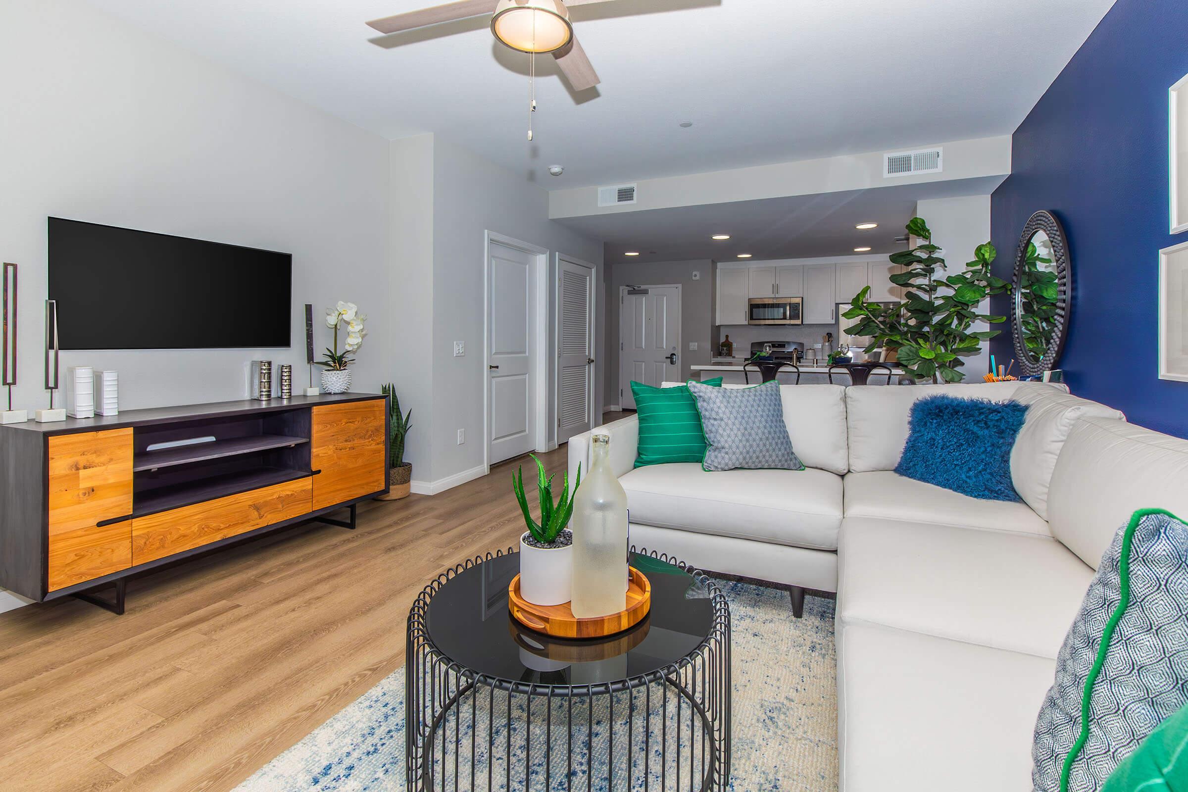 a living room filled with furniture and a flat screen tv