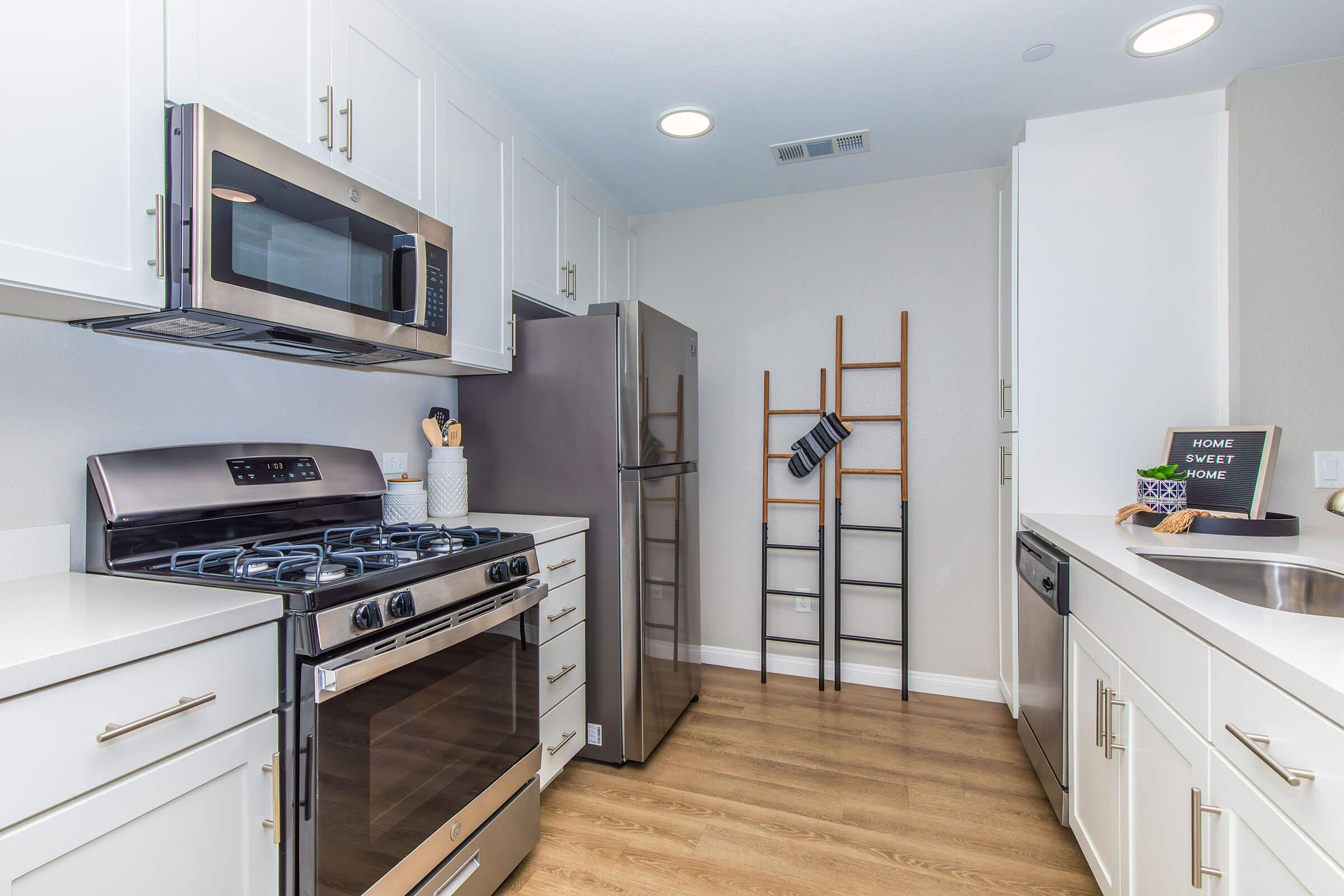 a stove top oven sitting inside of a kitchen