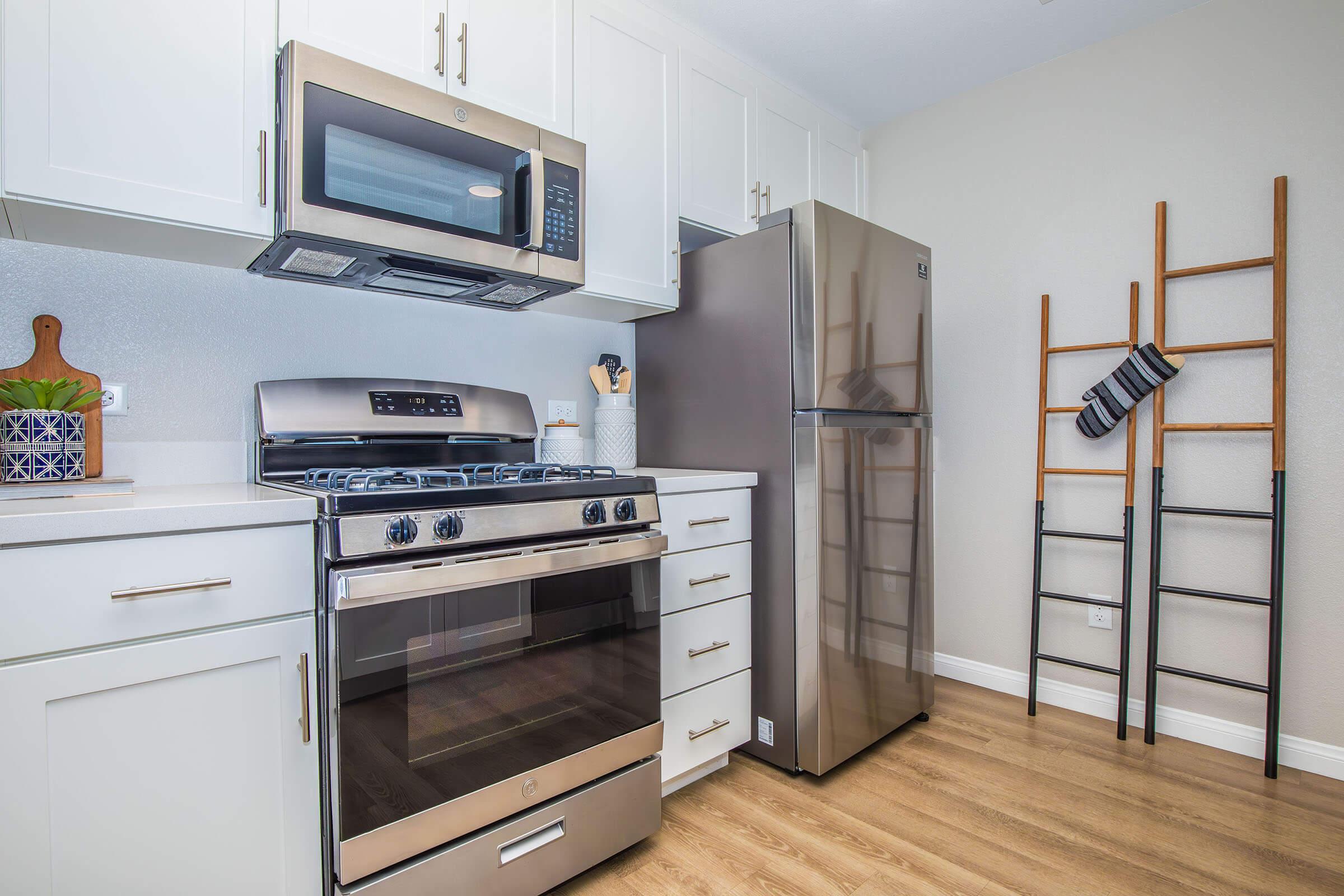 a stove top oven sitting inside of a kitchen