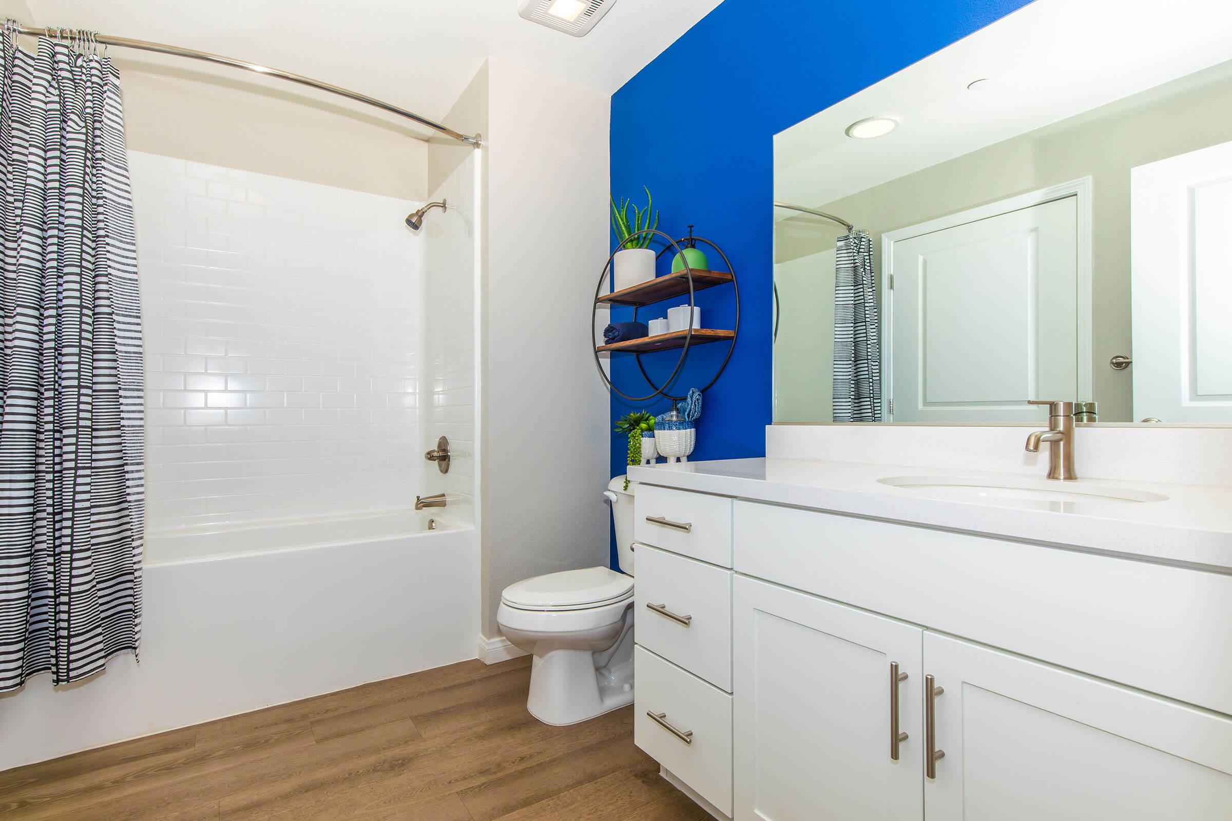Three-Bedroom Apartments in Santa Maria, CA - Azure Apartments - Bathroom with a Garden-Style Tub, Hardwood-Style Flooring, and a Large Vanity