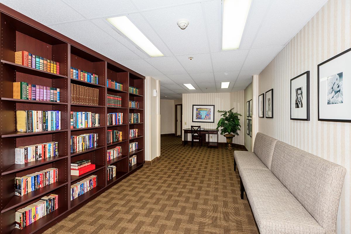 a room filled with furniture and a book shelf