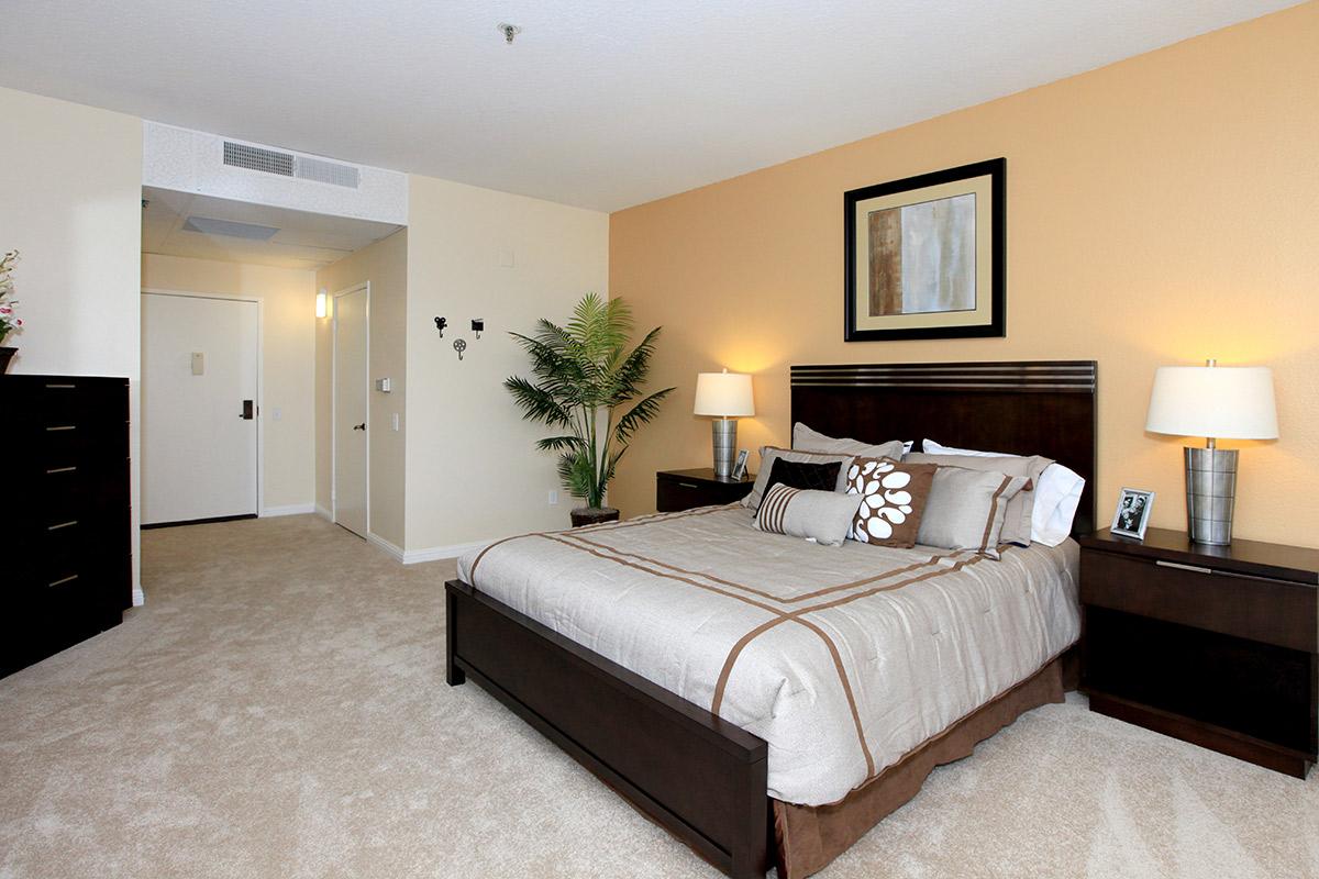 a bedroom with a large bed in a hotel room