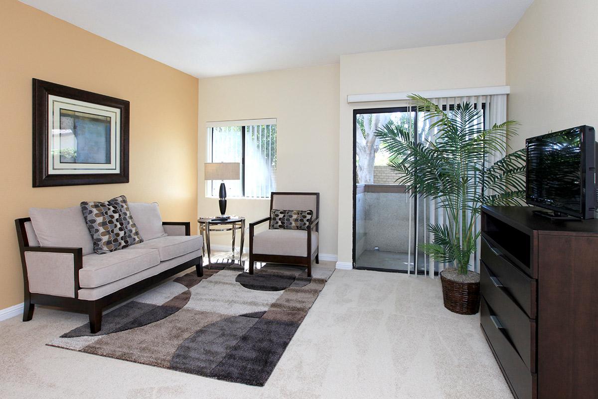 a living room filled with furniture and a flat screen tv