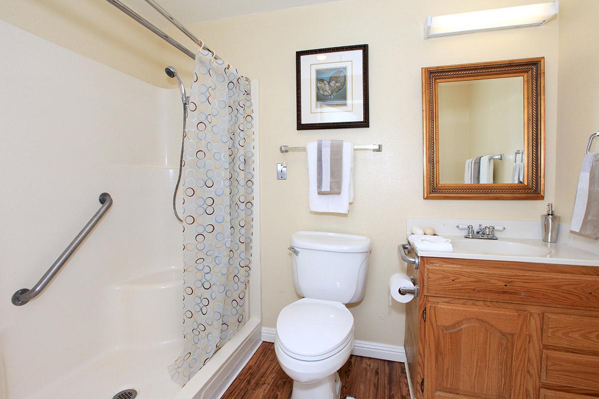a white tub sitting next to a shower