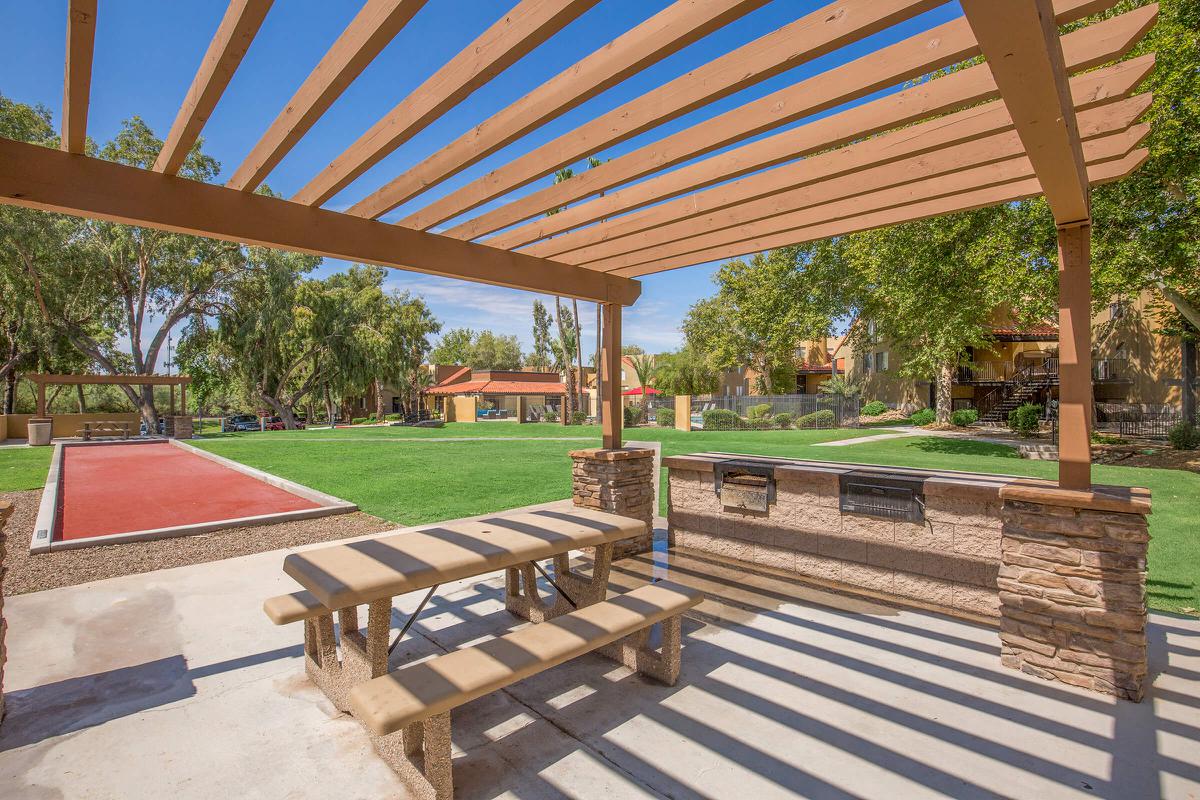 an empty park bench next to a building