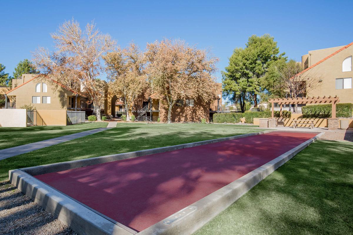 a close up of a basketball court in front of a house