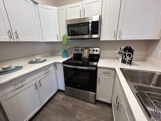 a stove top oven sitting inside of a kitchen